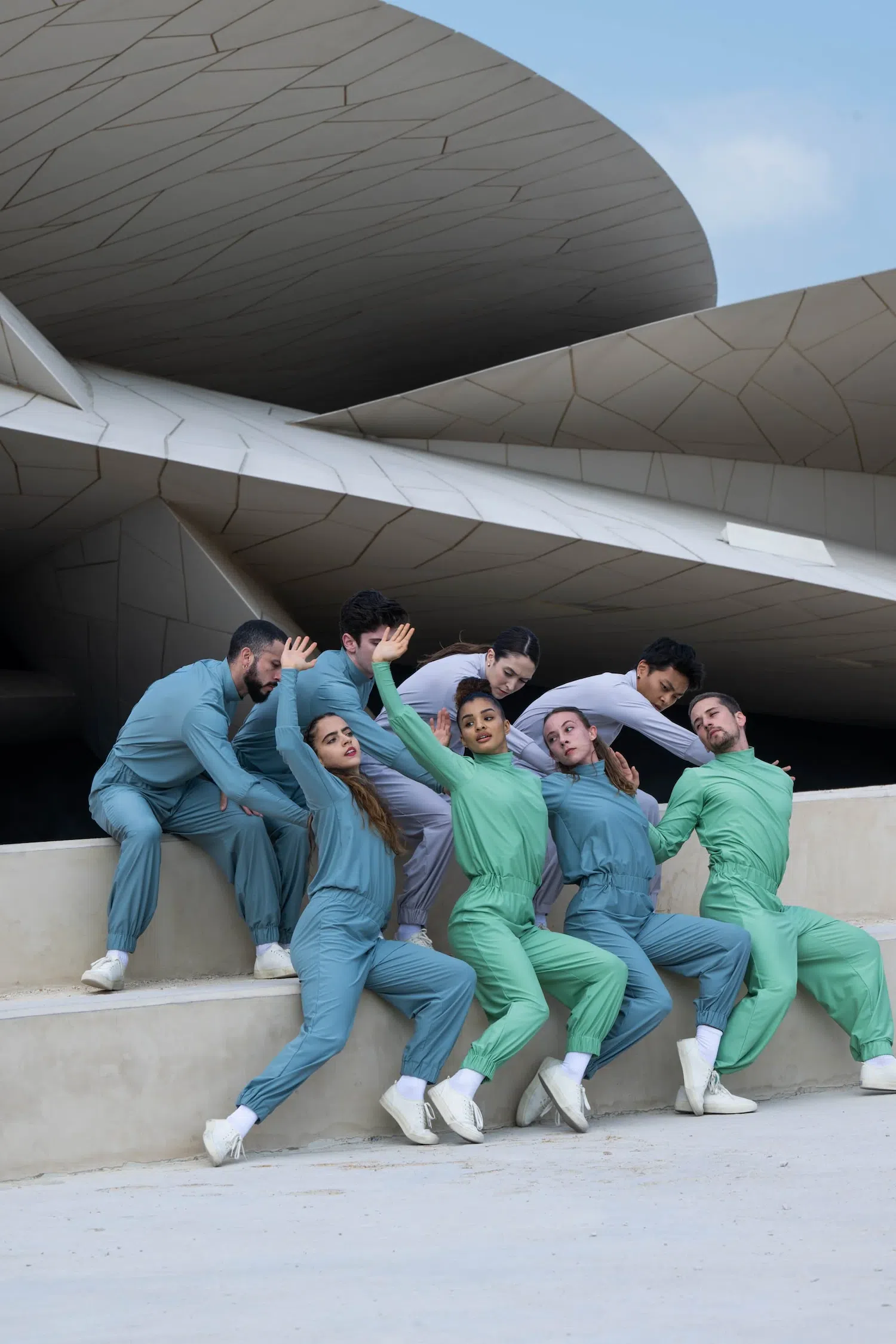 Dance photograph captured by Josh S. Rose, featuring a group of dancers in blue and green track suits