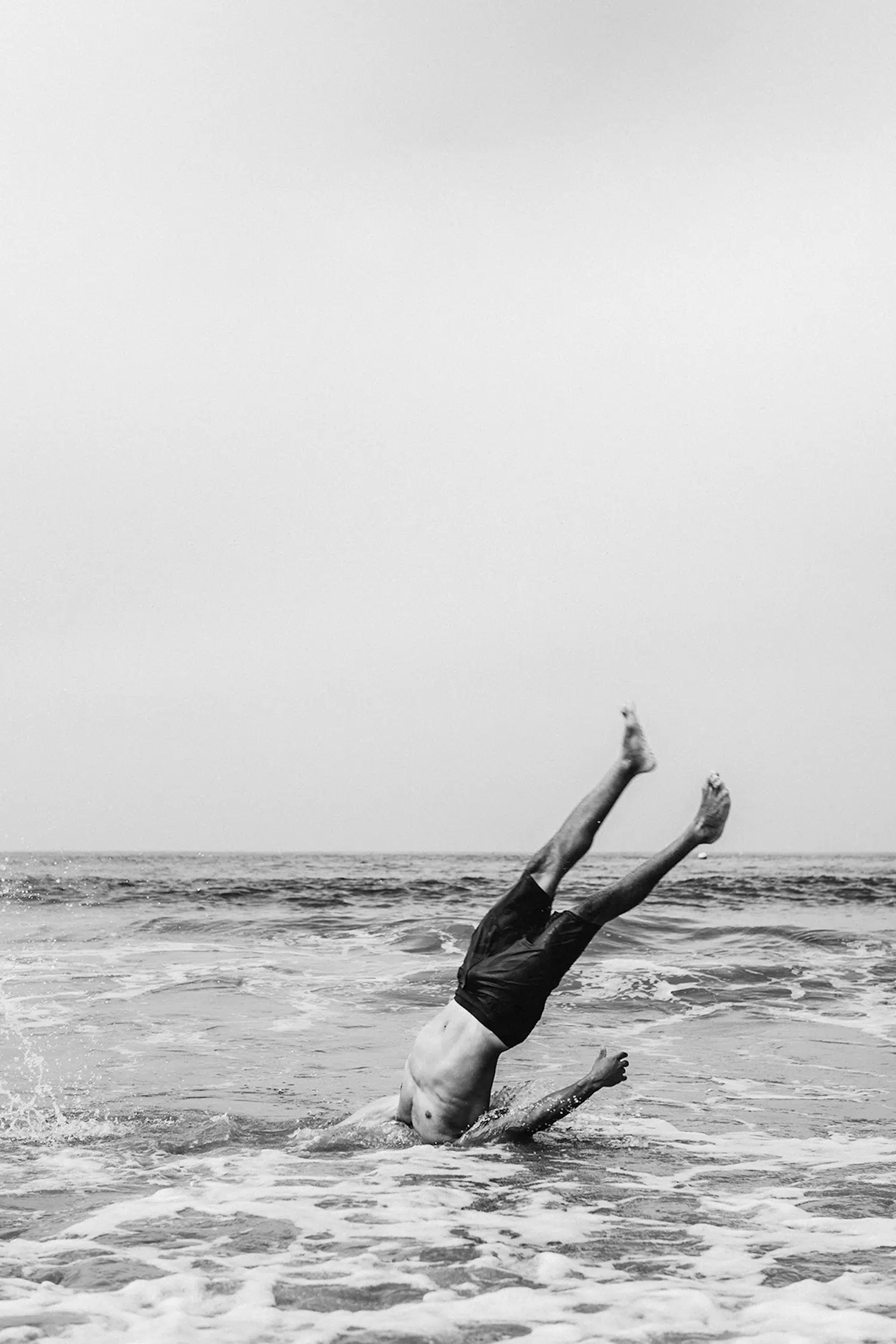 Dance photograph captured by Josh S. Rose, featuring a man with his head plunged into the ocean