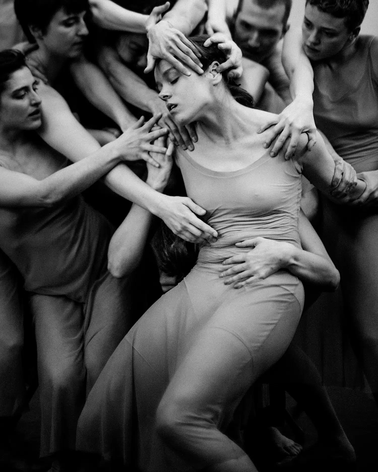 Dance photograph captured by Josh S. Rose, featuring a crowd of people grabbing onto one girl at the center of the image