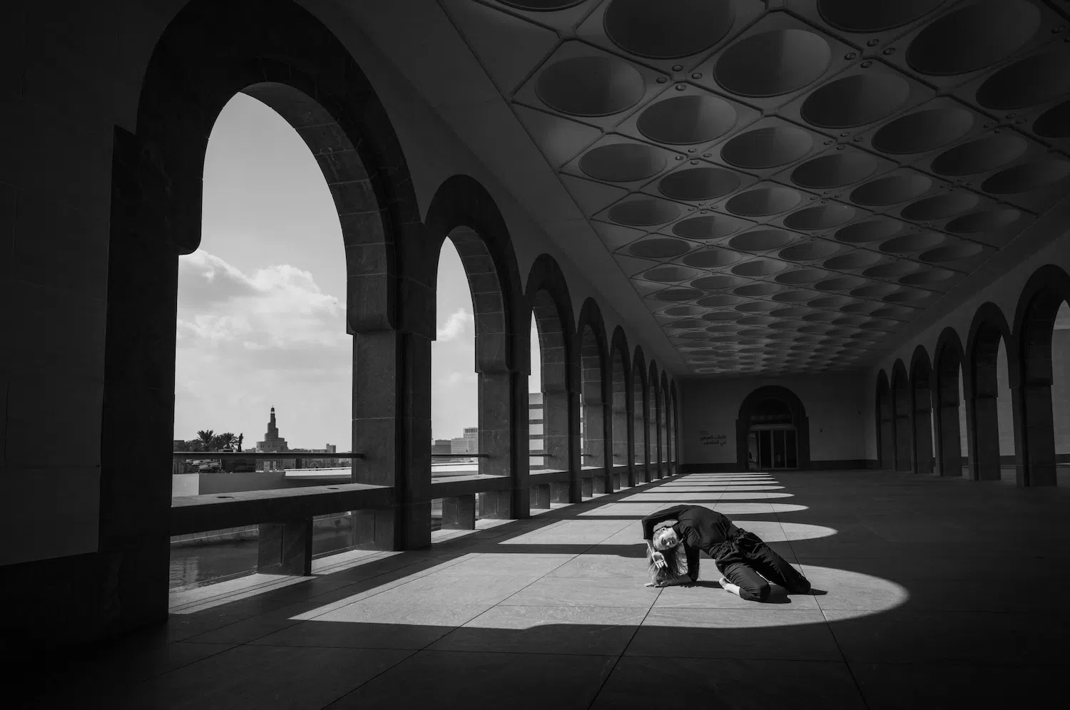 Dance photograph captured by Josh S. Rose, featuring a dancer on the ground inside an arched building