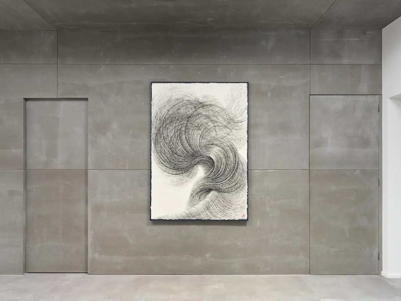 An artwork by Lee Hyun-Joung hanging on a concrete wall