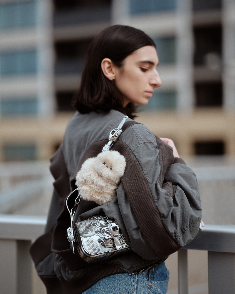 Woman holding handbag with Mirumi bag charm