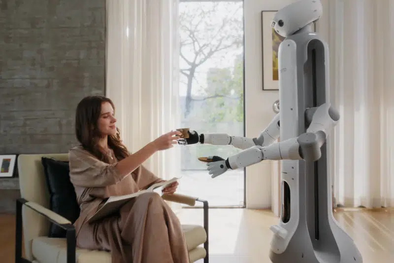 Switchbot Onero H1 handing a woman a drink