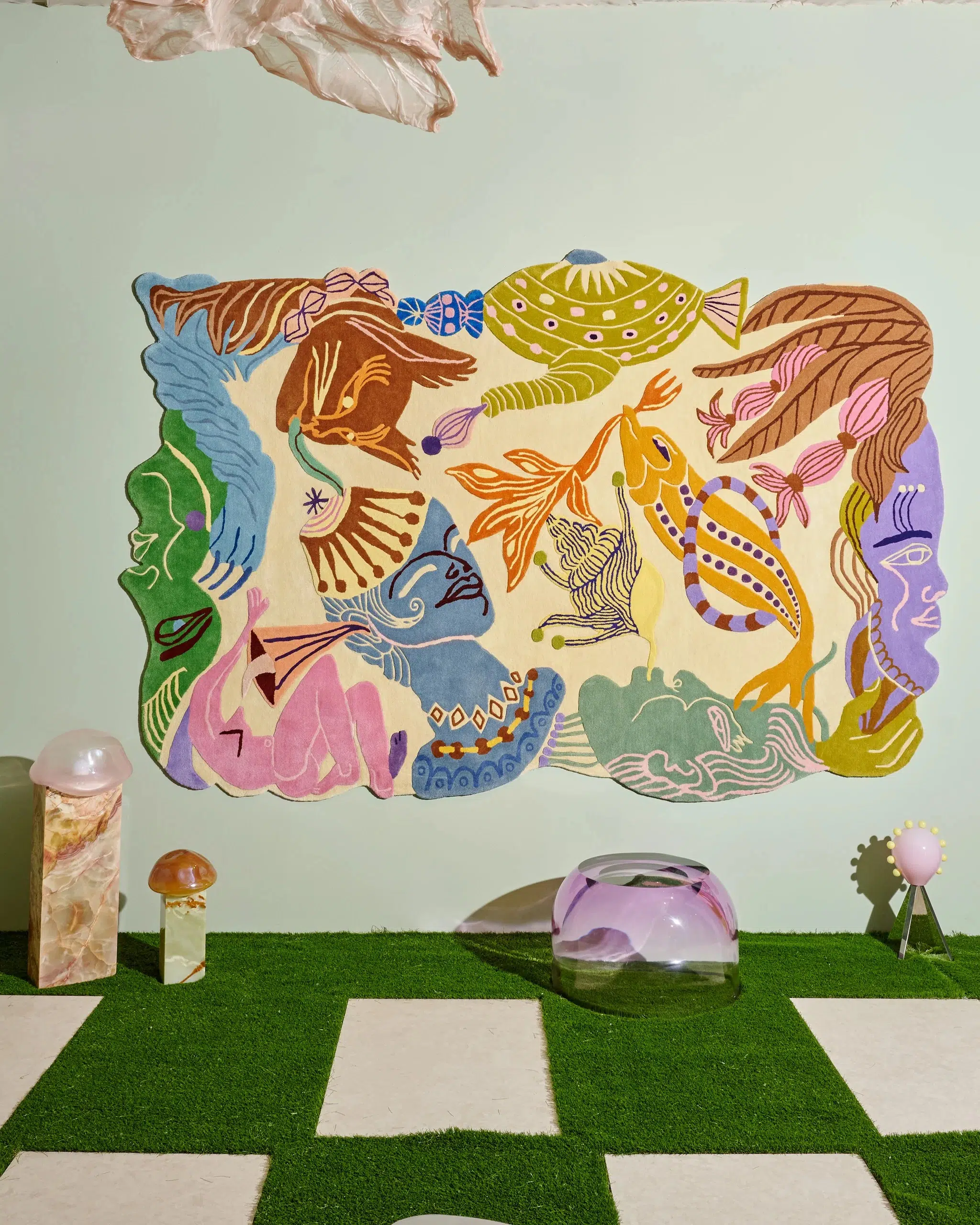 A playful, illustrative carpet tacked to the wall, as featured in Tuleste Factory’s ‘Keep It Curious’ booth at Design Miami 2025