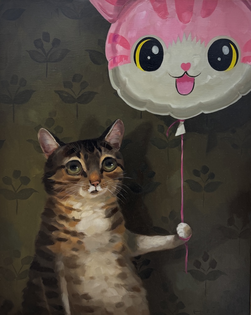 cat holding a balloon