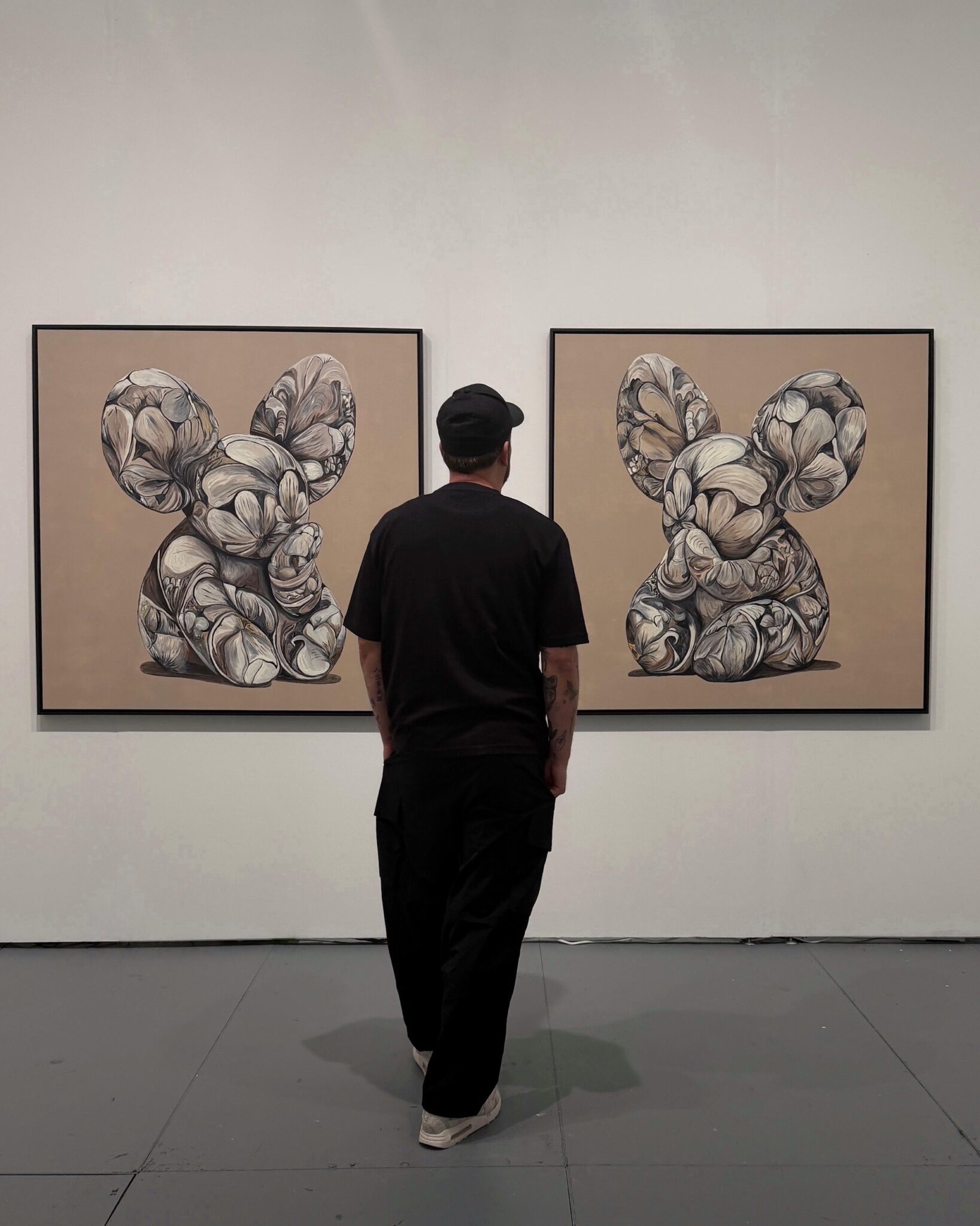 Two artworks by Marcel van Luit hanging on a wall