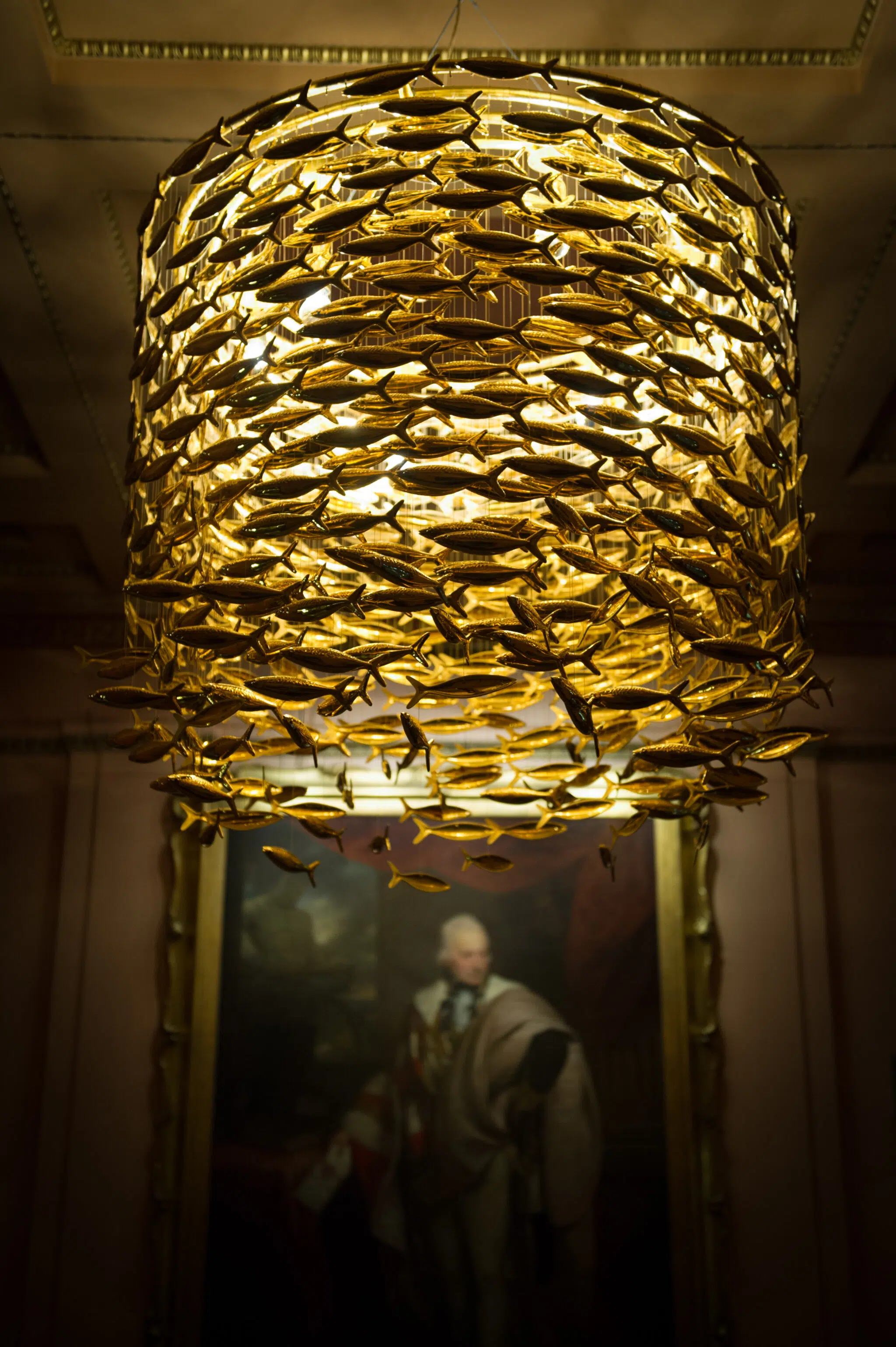 A chandelier composed of golden fish hanging from the ceiling