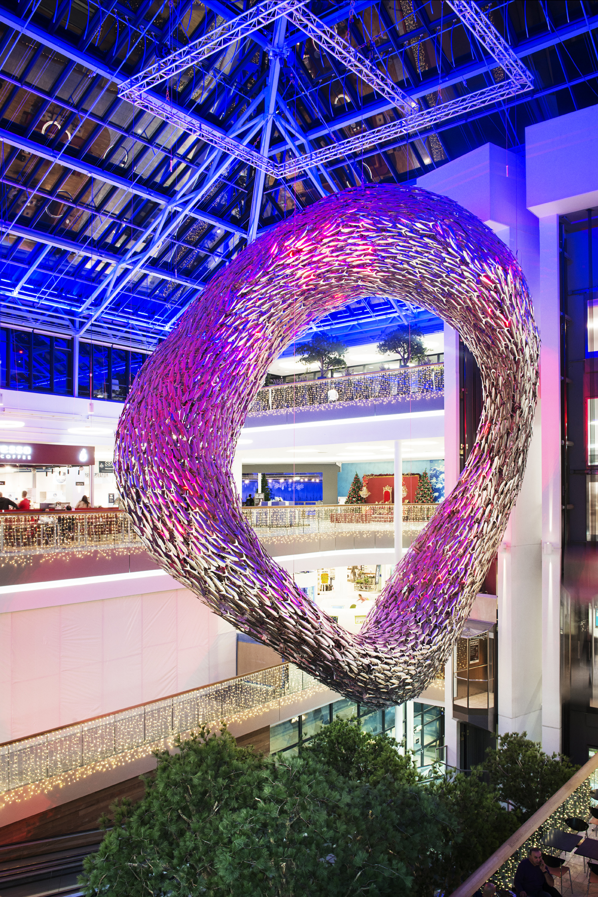 A complex Scabetti chandelier composed of glass fish hanging from the ceiling