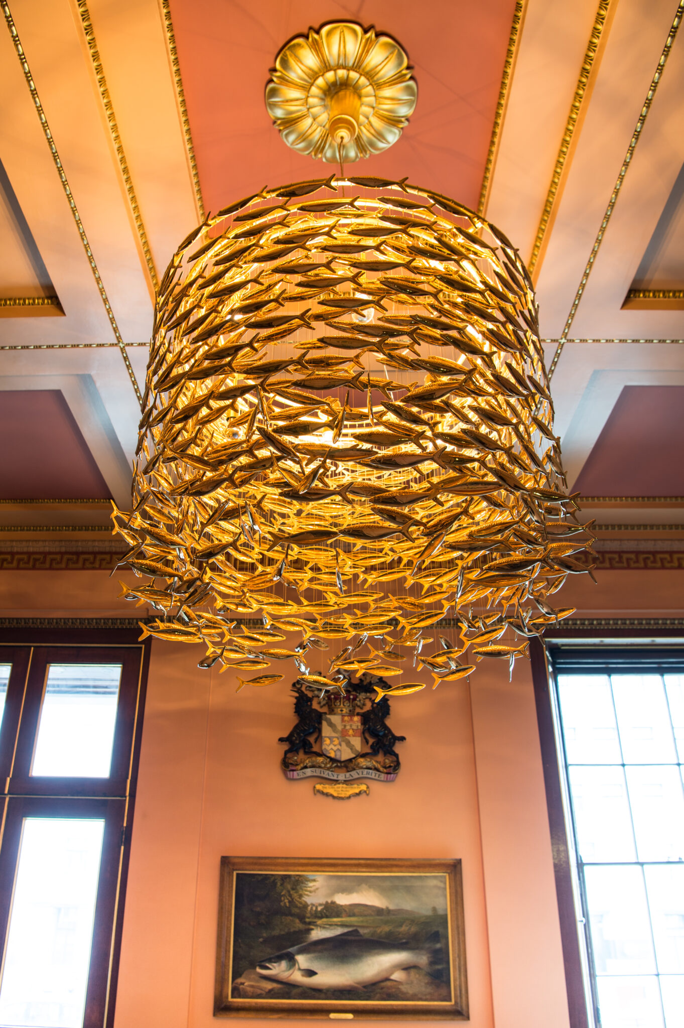 A Scabetti chandelier composed of golden fish hanging from the ceiling