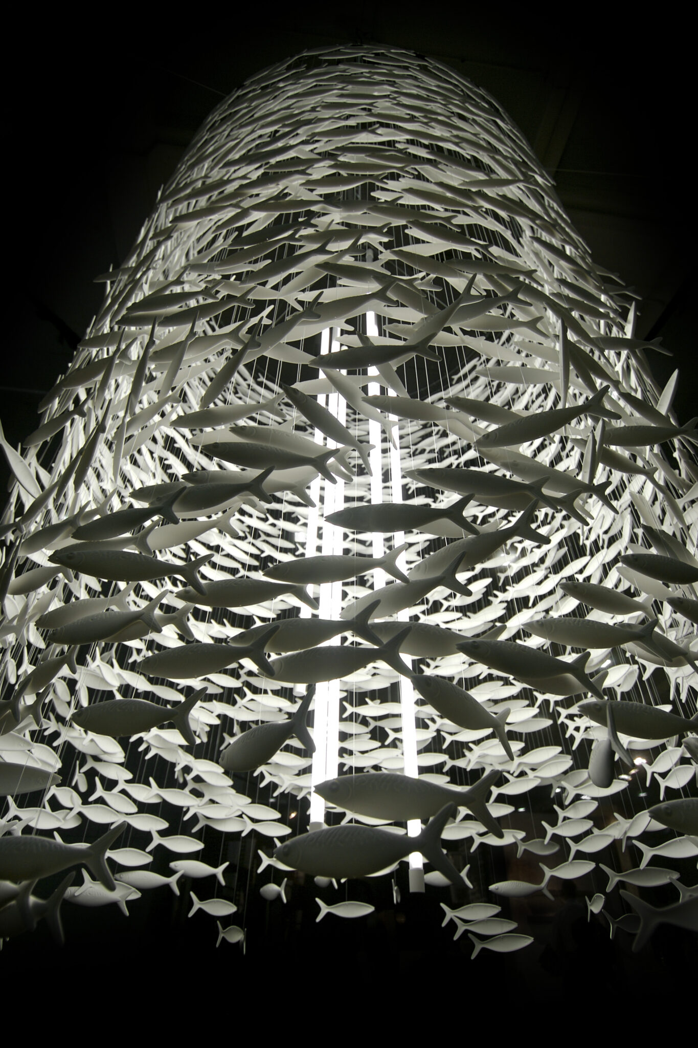 A Scabetti chandelier composed of white ceramic fish hanging from the ceiling