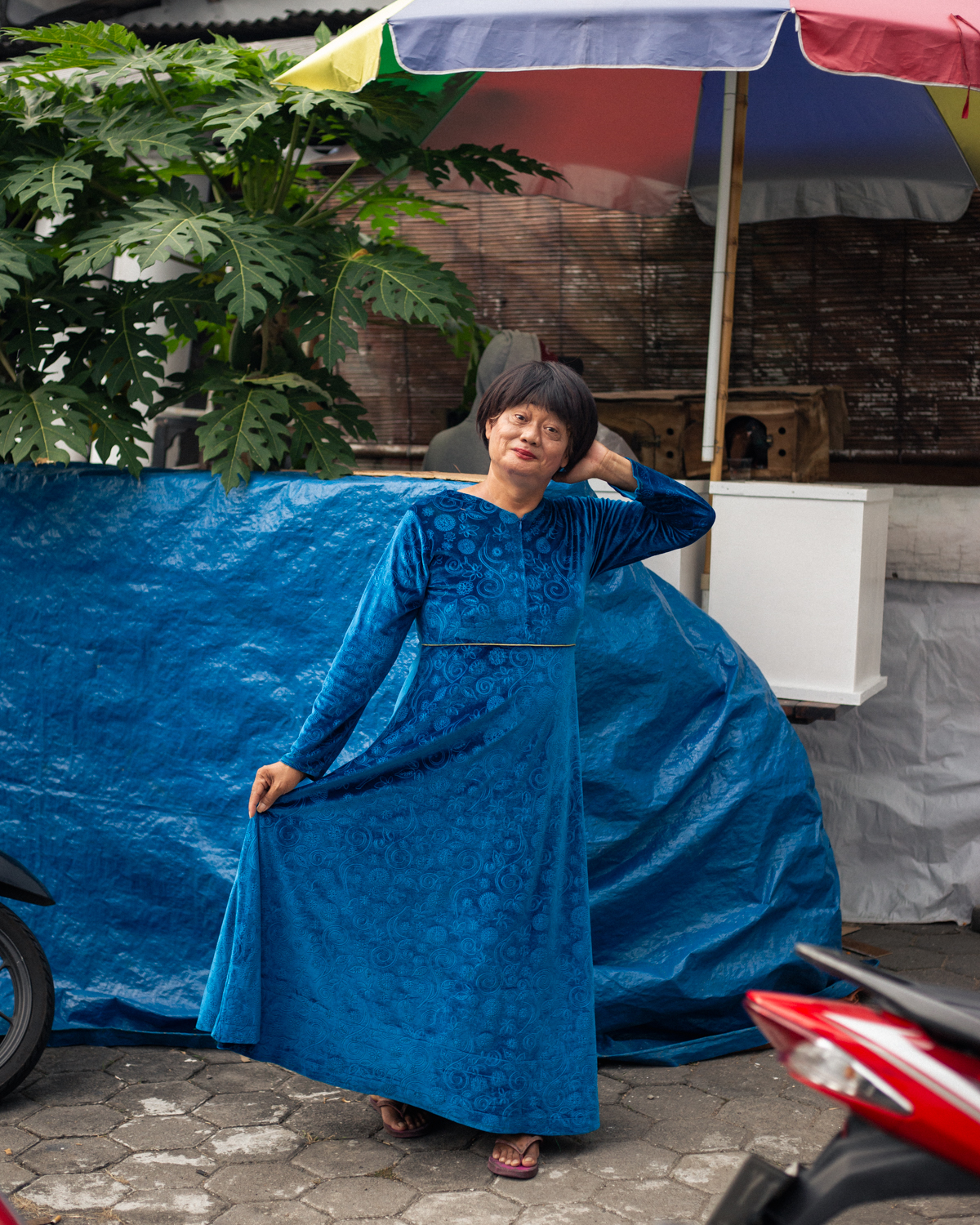 Rini, 56, stands in the front yard of Pondok Pesantren Al-Fatah, a Quranic school for trans women. Rini earns her income as a street musician and regularly attends Pondok Pesantren Al-Fatah to study the Quran and pray with friends from the queer community.