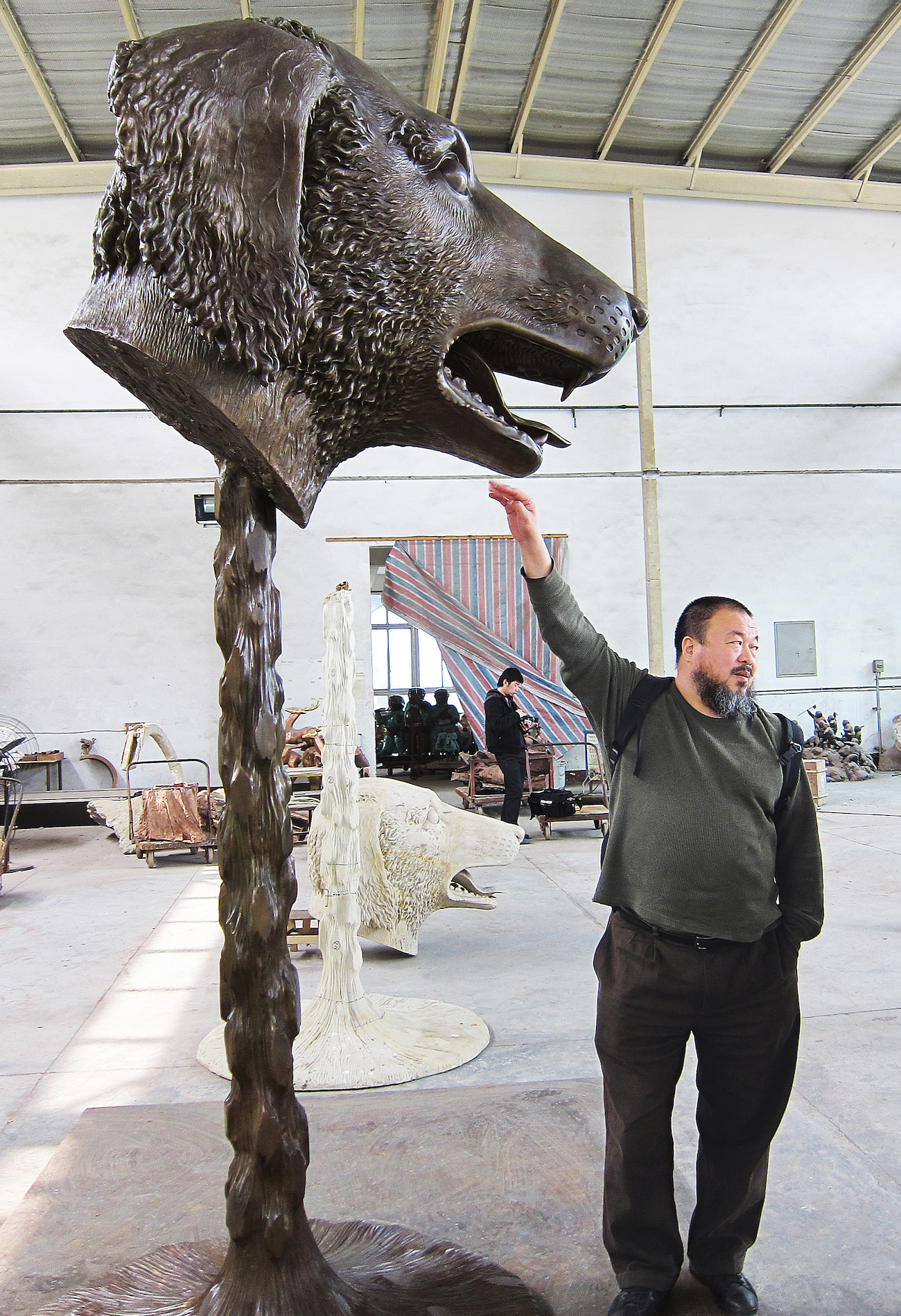 The artist with the finished dog sculpture from &ldquo;Circle of Animals/Zodiac Heads,&rdquo; 2010. Bronze, 1 of 12 pieces.