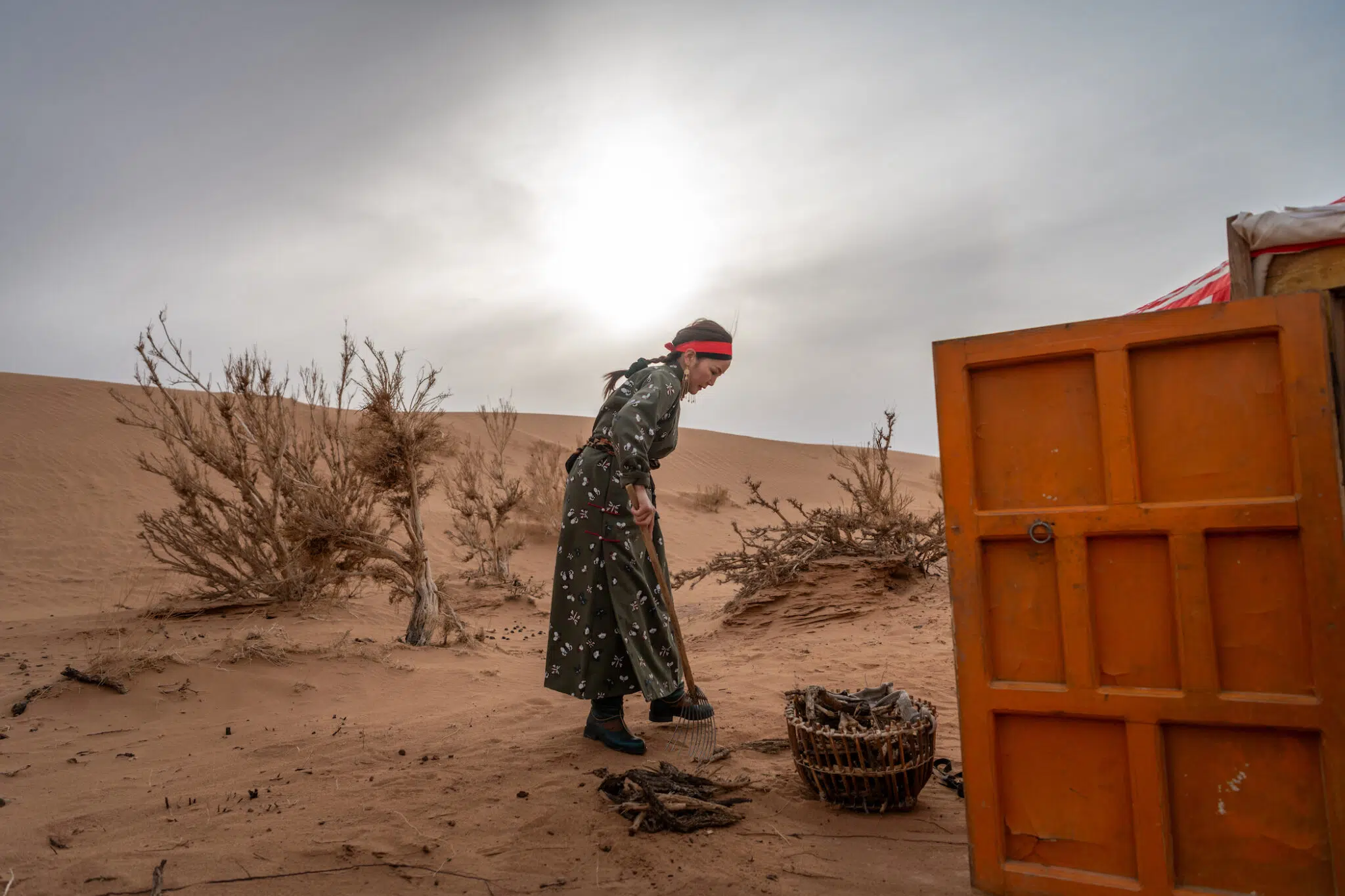 A woman in Mongolia outside of her hut