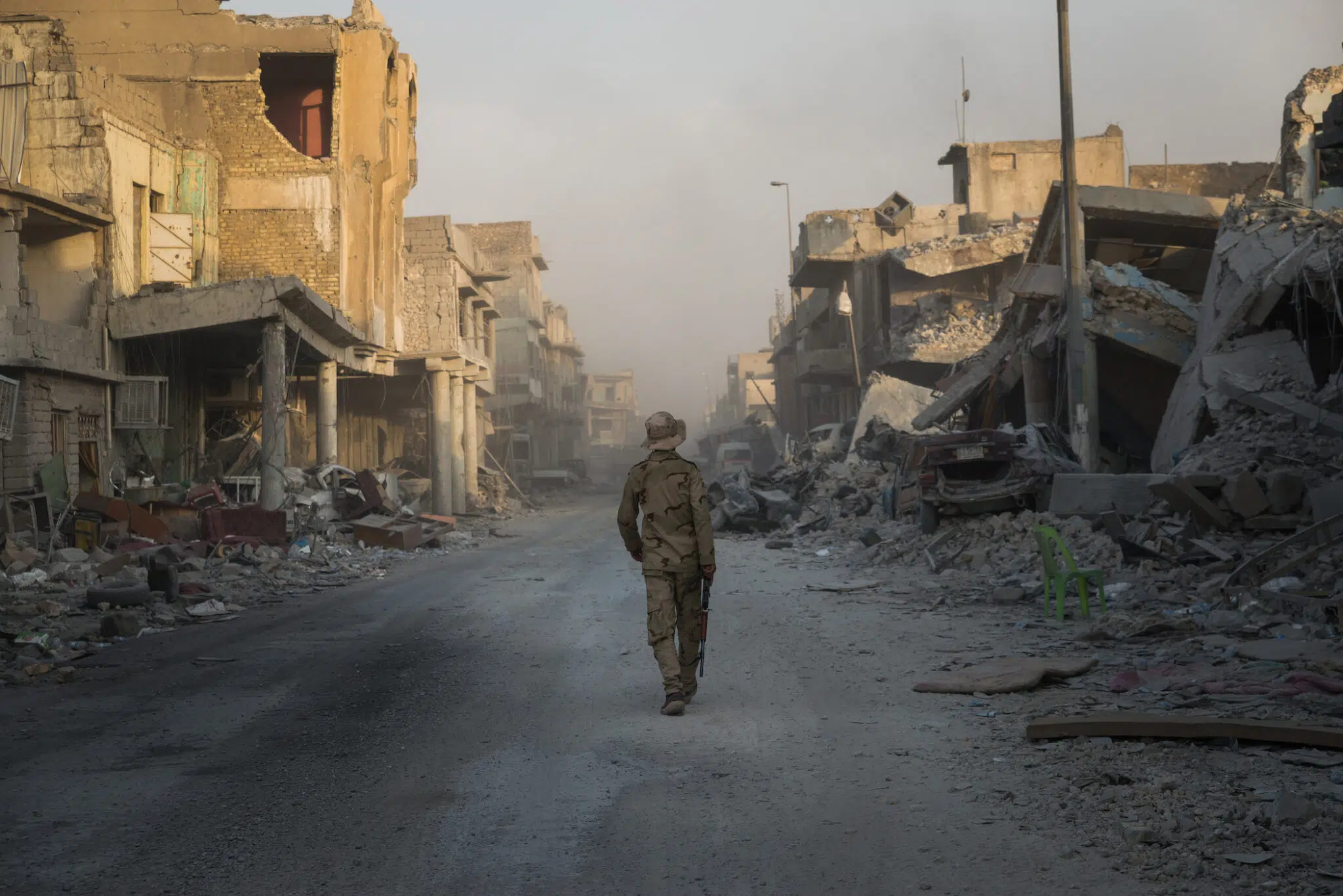 An Iraqi soldier walks along a street in Mosul's devastated Old City as Iraq's Prime Minister Haider al-Abadi declared victory against the Islamic State in Mosul.