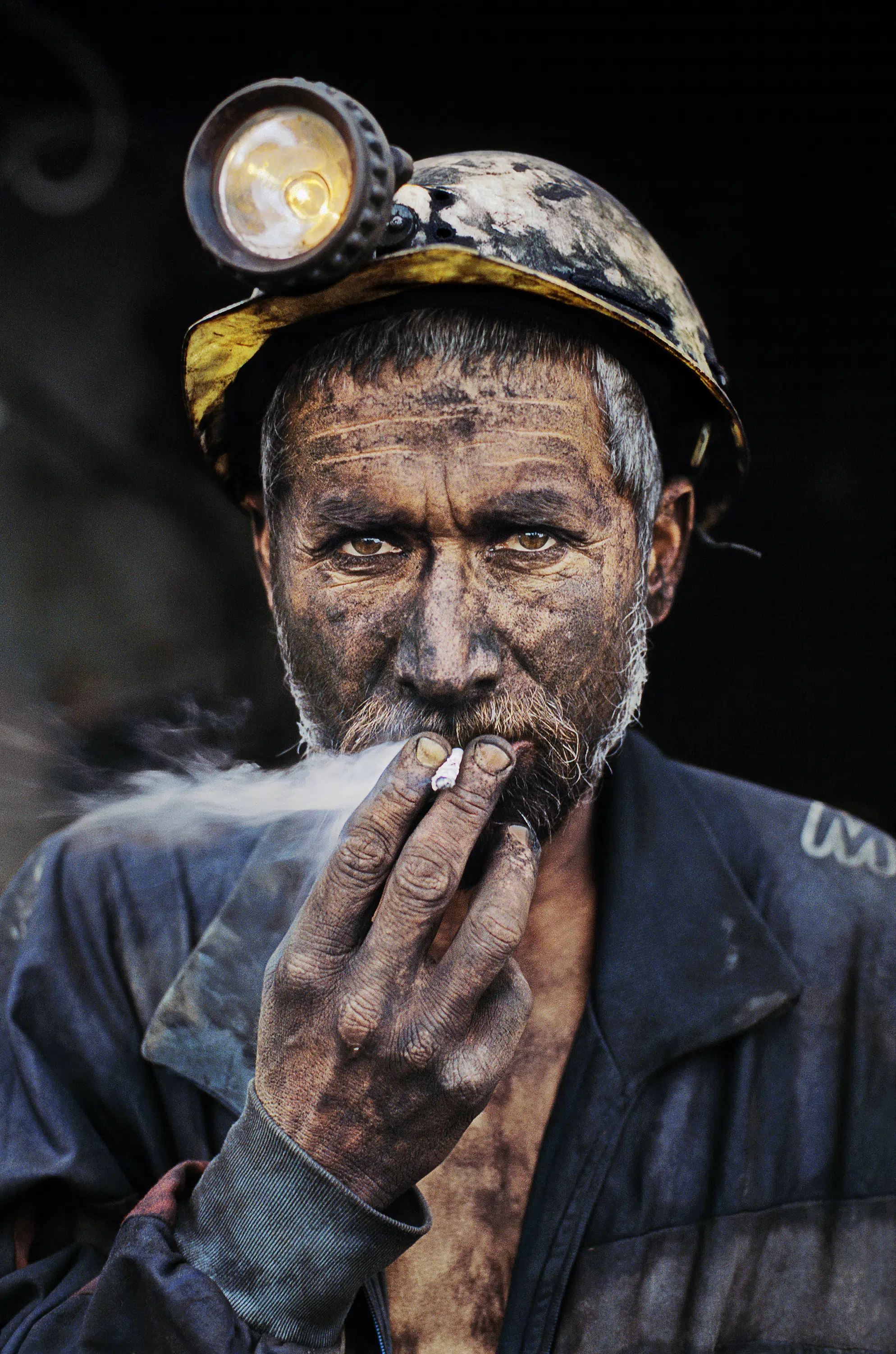 Steve McCurry, &ldquo;Coal Miner Smoking,&rdquo; Pol-e-Khomri, Afghanistan, 2002.