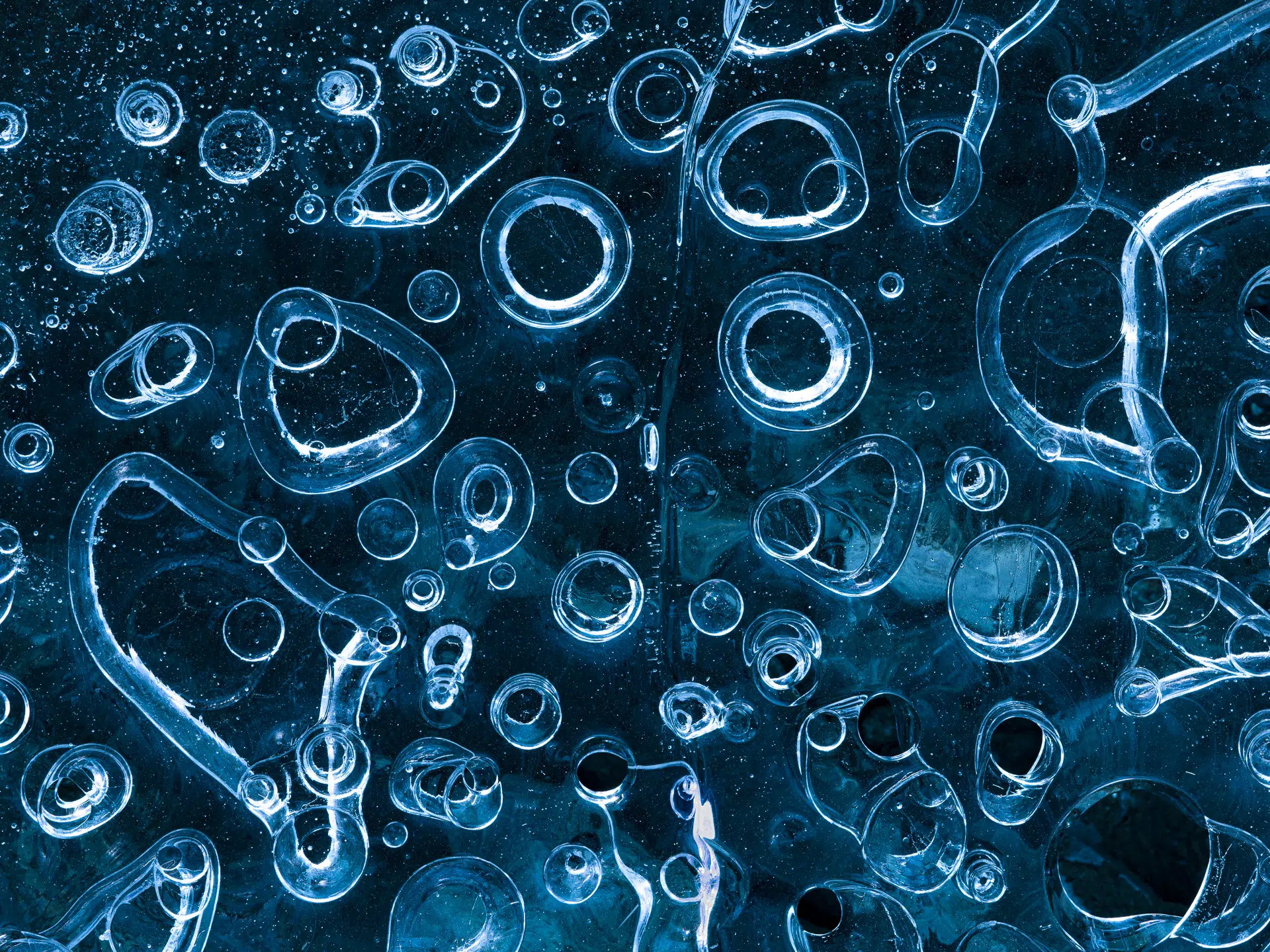 &ldquo;Ice Bubbles,&rdquo; Iceland, 2023. As glaciers melt in southern Iceland, ice caves are born. This cave, deep within the Vatnaj&ouml;kull glacier, was flash-flooded, and the cold was so intense that air bubbles froze into delicate rings across the cave floor with each ring measuring between one and three inches in diameter.