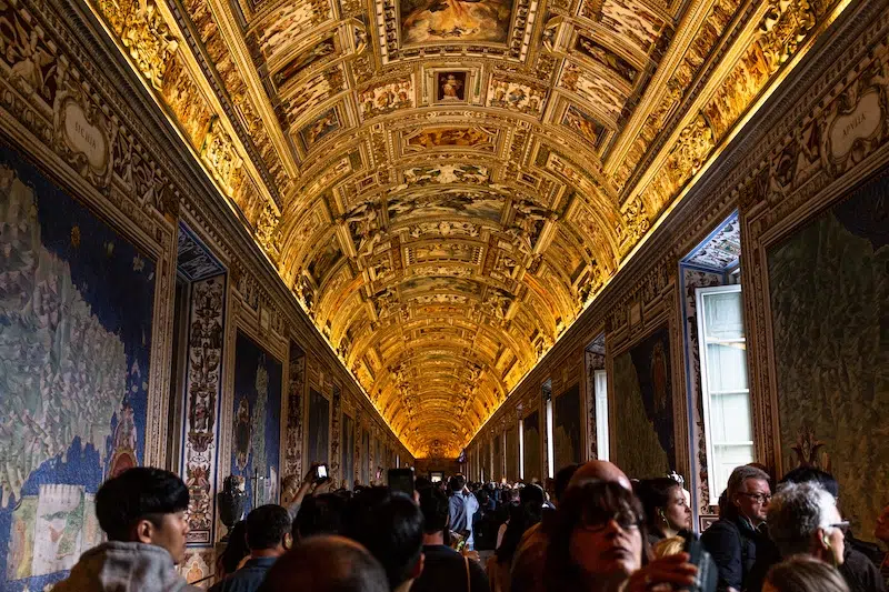 Crowd of tourists walking through the Vatican Museums