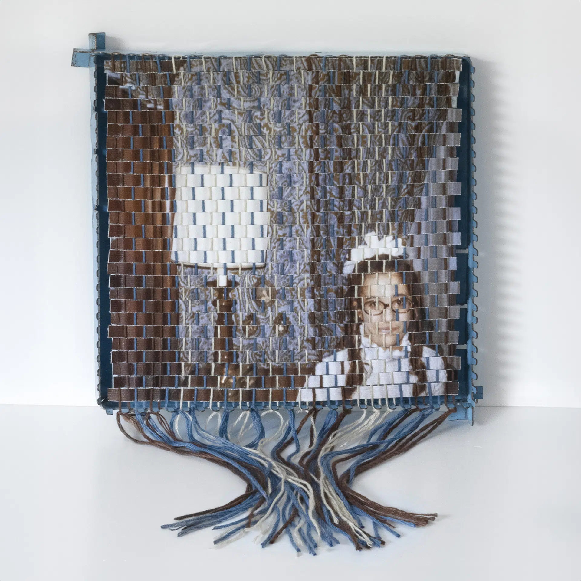 A family photograph that has been torn apart and resewn using a vintage pot holder loom, created by Pam Connolly for her &ldquo;Columbus Drive&rdquo; series