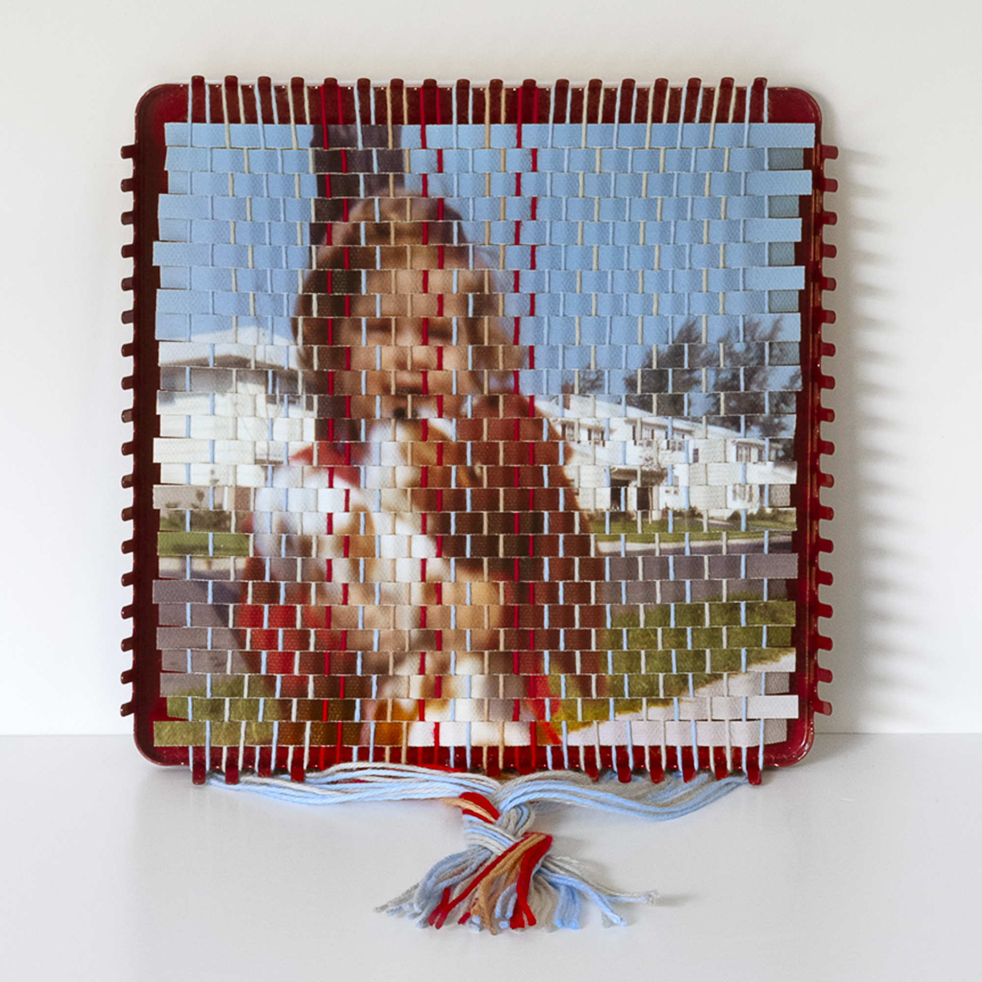 A family photograph that has been torn apart and resewn using a vintage pot holder loom, created by Pam Connolly for her &ldquo;Columbus Drive&rdquo; series