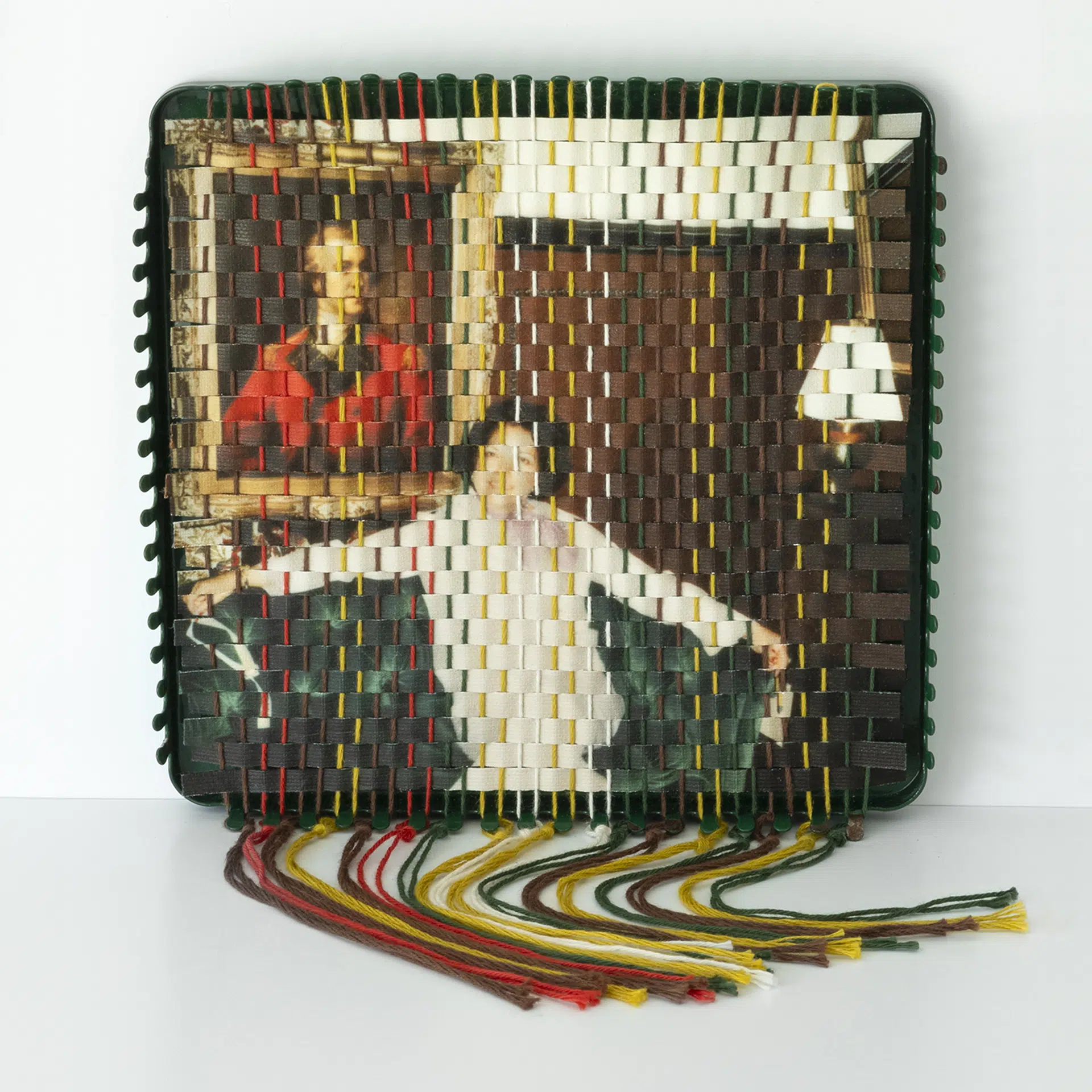 A family photograph that has been torn apart and resewn using a vintage pot holder loom, created by Pam Connolly for her &ldquo;Columbus Drive&rdquo; series