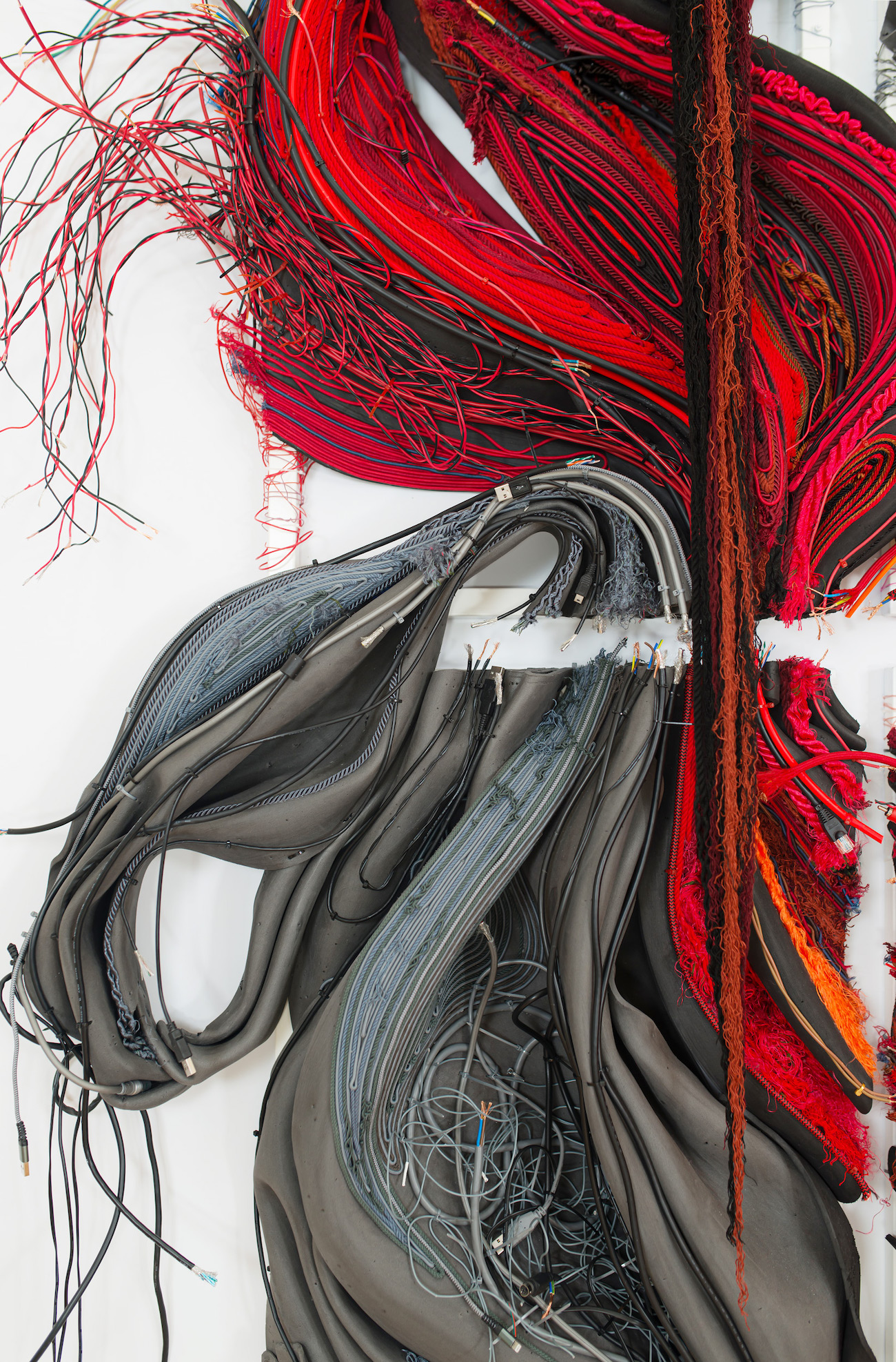 Glimpse, 2025. String, yarn, discarded electrical cable, rubber tube, elastic cord, foam, and cloth.