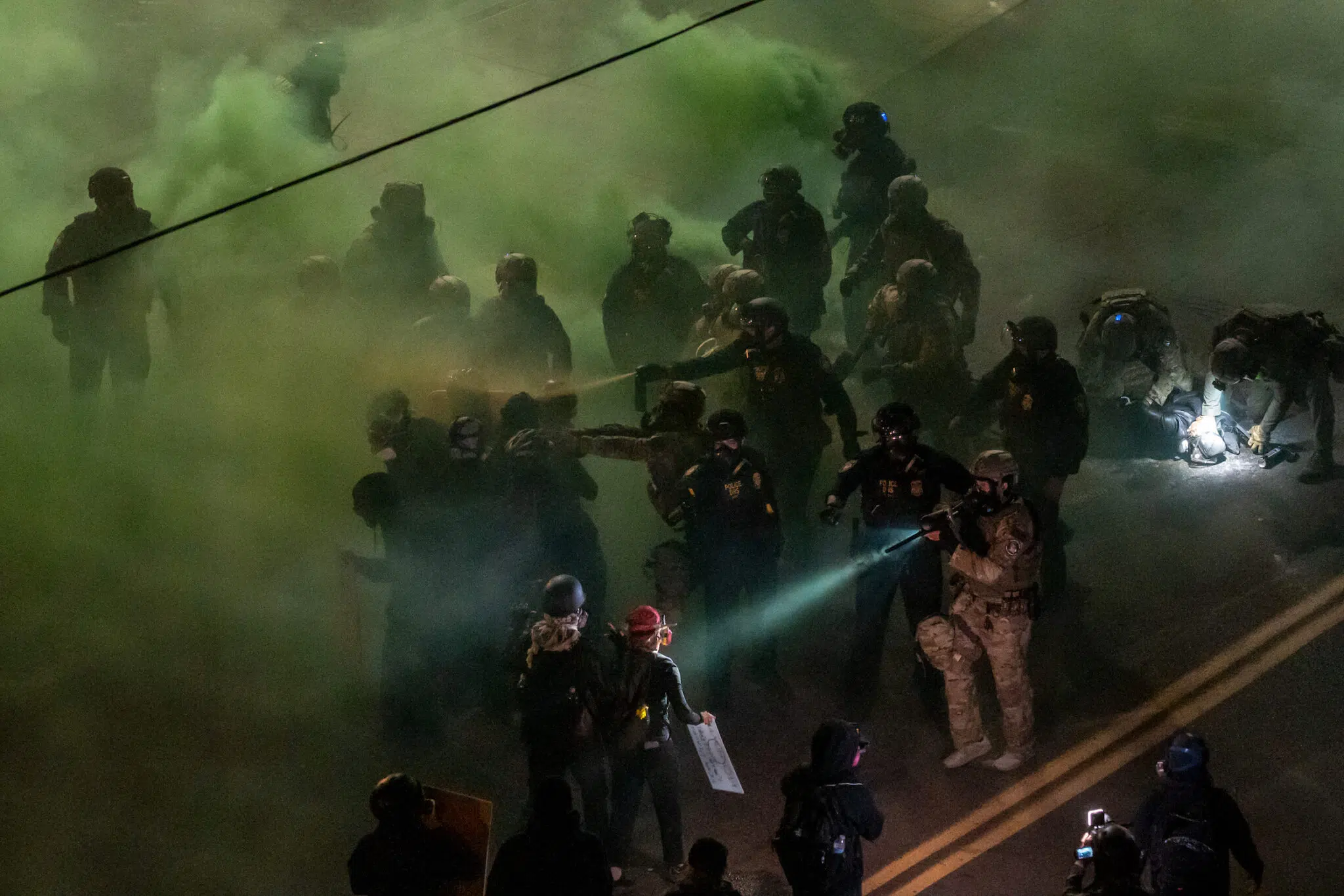Jan Sonnenmair, &ldquo;Portland Protests ICE.&rdquo; Officers from the DHS and other federal agencies clash with demonstrators outside an ICE processing center. The intense summer protests centered on opposing the administration&rsquo;s escalating mass-deportation agenda. Portland, Ore., June 24, 2025.