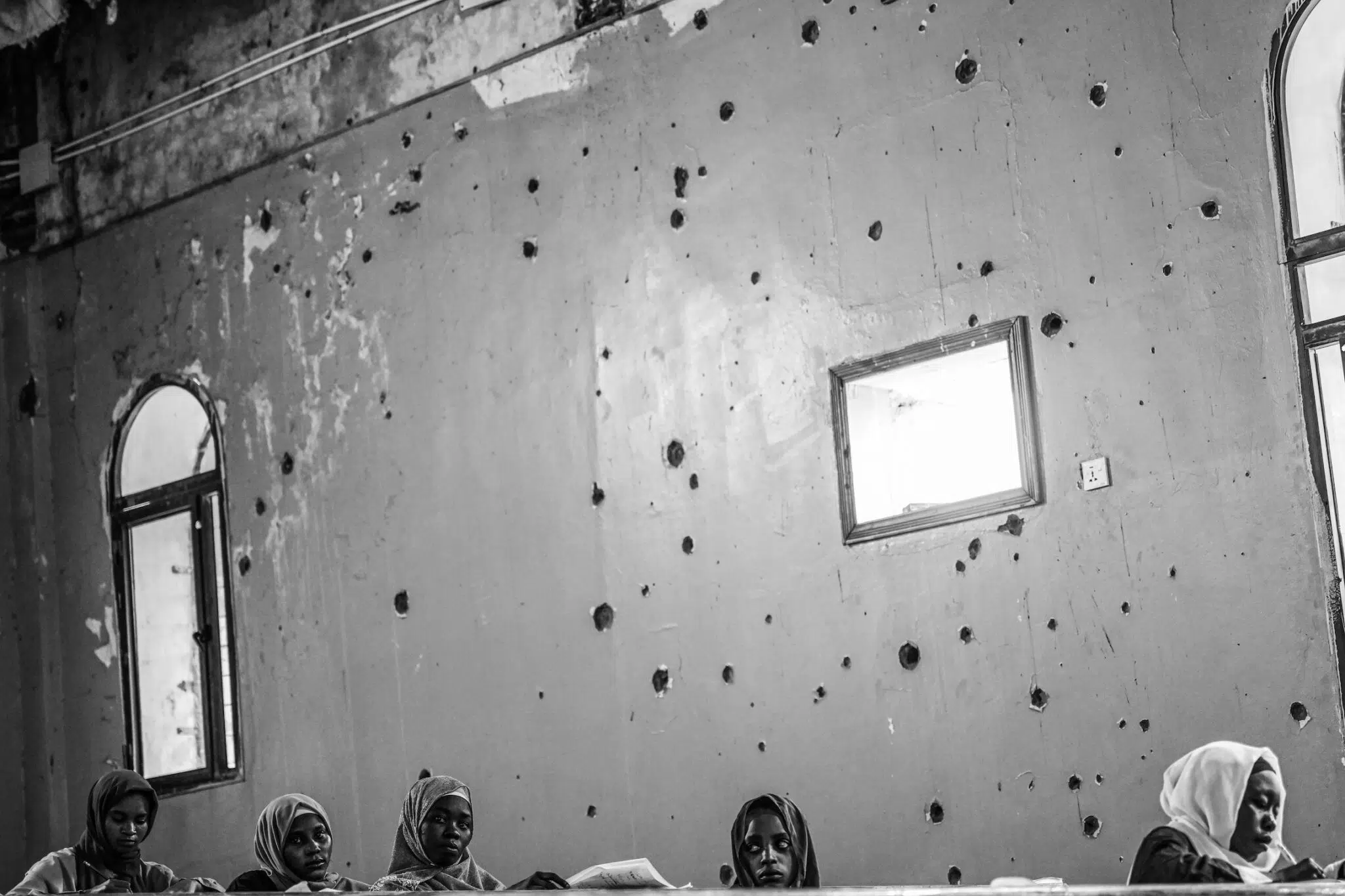 Abdulmonam Eassa, &ldquo;Sudan&rsquo;s War: A Nation Trapped,&rdquo; for Le Monde. Students take exams at the war-damaged Omdurman Islamic University. Schools and universities have been attacked and mostly closed since fighting began. Omdurman, Sudan, December 4, 2025.