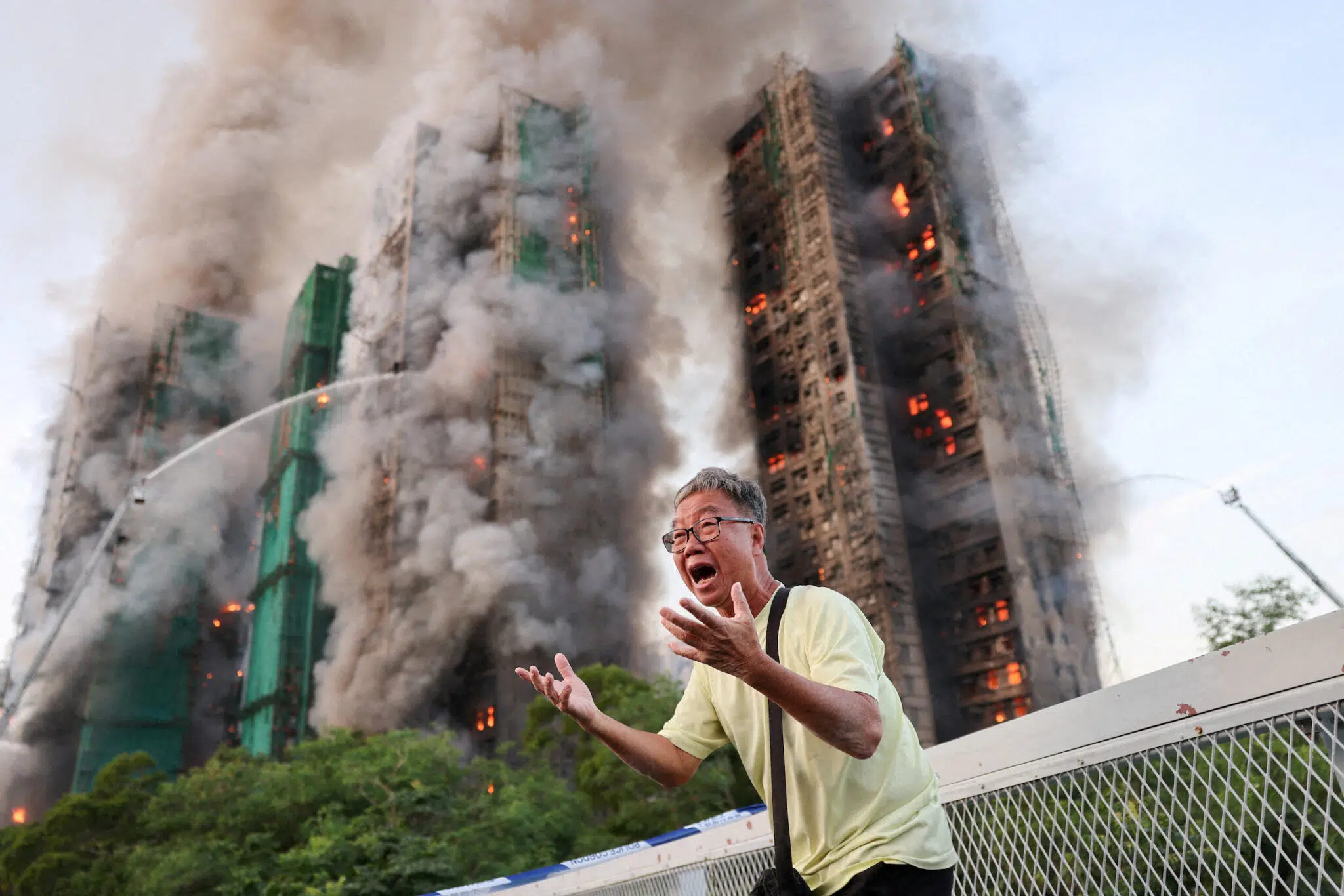 Tyrone Siu, &ldquo;A Desperate Plea,&rdquo; for Reuters. Mr. Wong cries out in anguish as fire engulfs the Tai Po housing complex he calls home. Moments earlier, he phoned his wife, who was trapped in the building, and they exchanged what would be their final words. Hong Kong, November 26, 2025.
