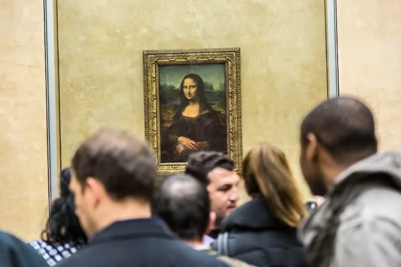 Visitors taking photo of Leonardo Da Vinci's "Mona Lisa" at the Louvre Museum in Paris, France.