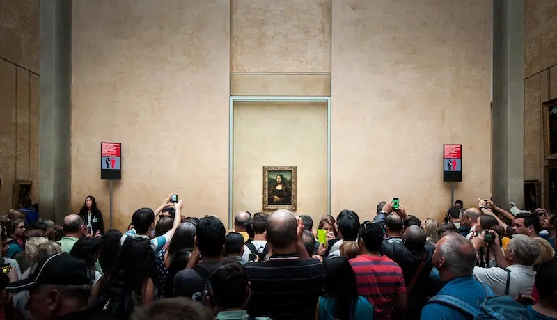 Visitors taking photo of Leonardo Da Vinci's "Mona Lisa" at the Louvre Museum in Paris, France.