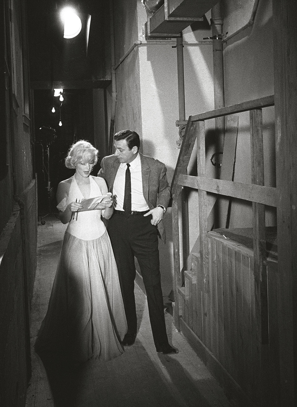 Monroe and co-star Yves Montand discuss the opening scene of &ldquo;Let&rsquo;s Make Love&rdquo; on set, 1960.