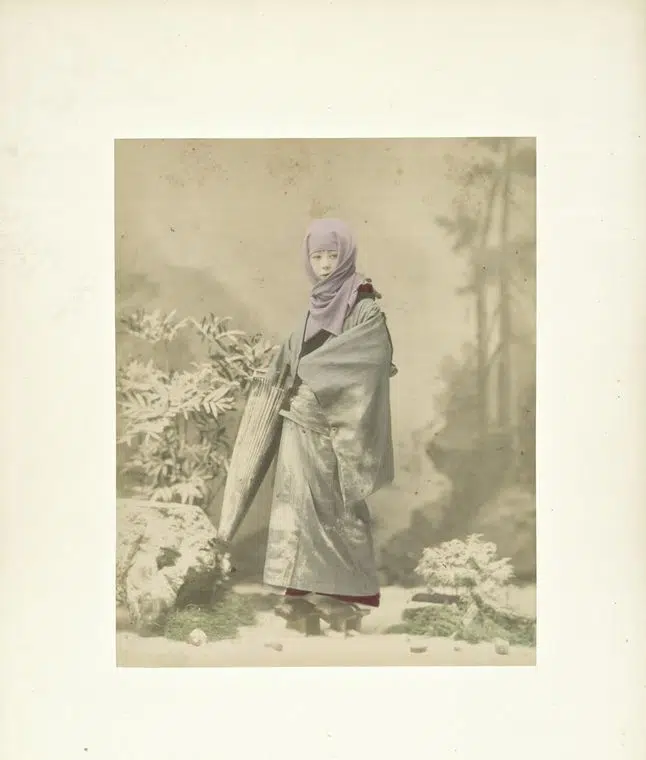 Hand-colored photograph of a woman wearing a headscarf in 19th-century Japan