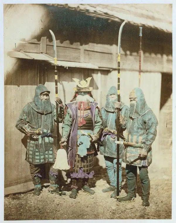 Hand-colored photograph of four men in ancient armor in 19th-century Japan