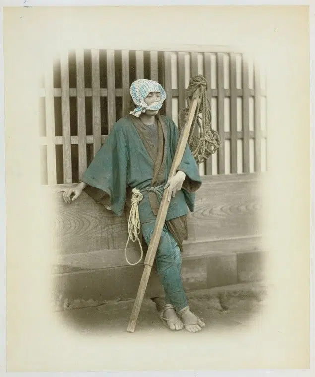 Hand-colored photograph of a "coolie" in 19th-century Japan
