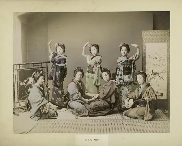 Hand-colored photograph of a group of dancers in 19th-century Japan