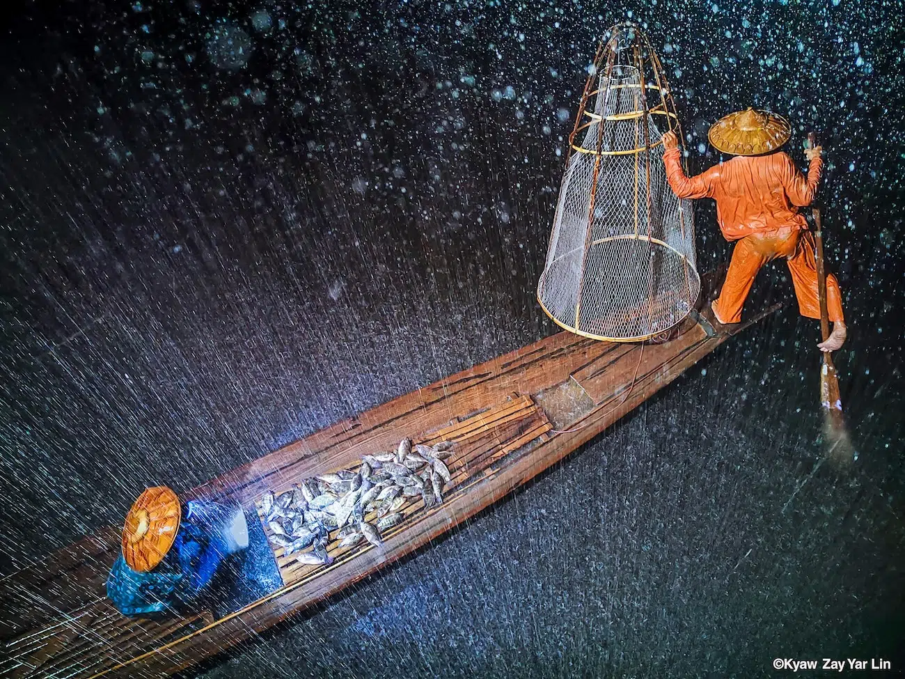 Fisherman working as rain pelts down