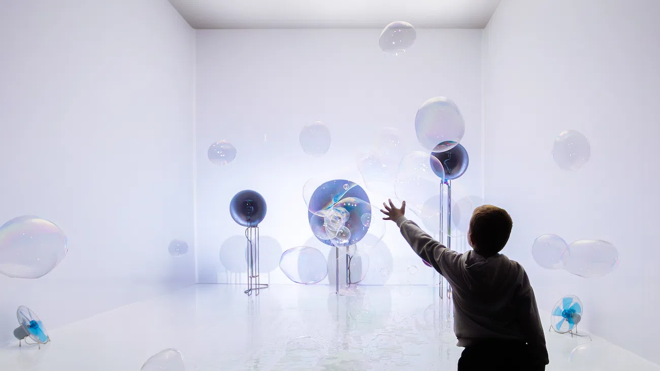 Child in room with instruments and balloons.