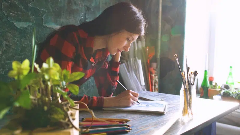 Person Drawing at Desk