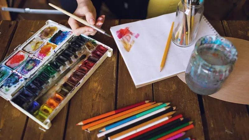 Painting on Paper with Colored Pencils on Table