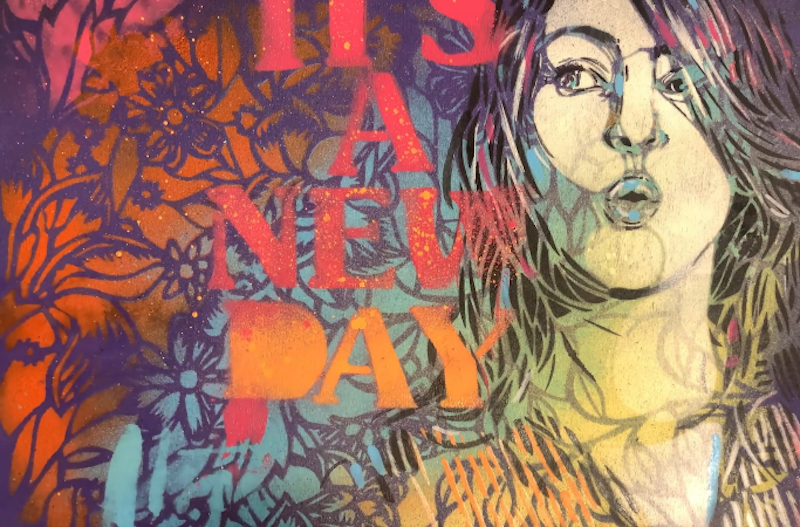 Stencil portrait of a woman with "It's a new day" next to her