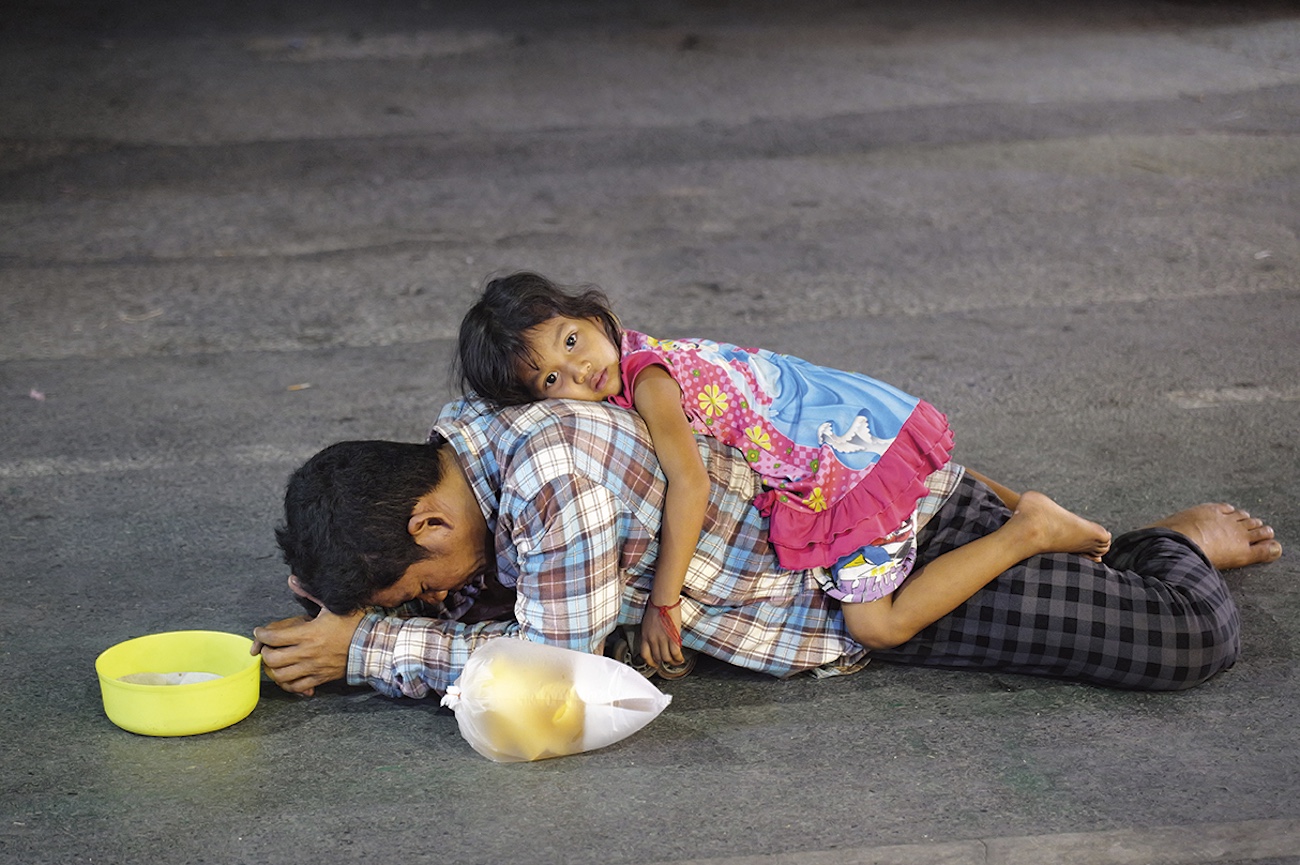 Child laying on back of father