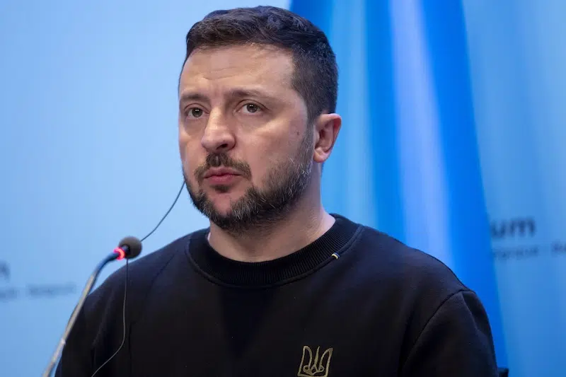 Volodymyr Zelenskyy speaking into a microphone