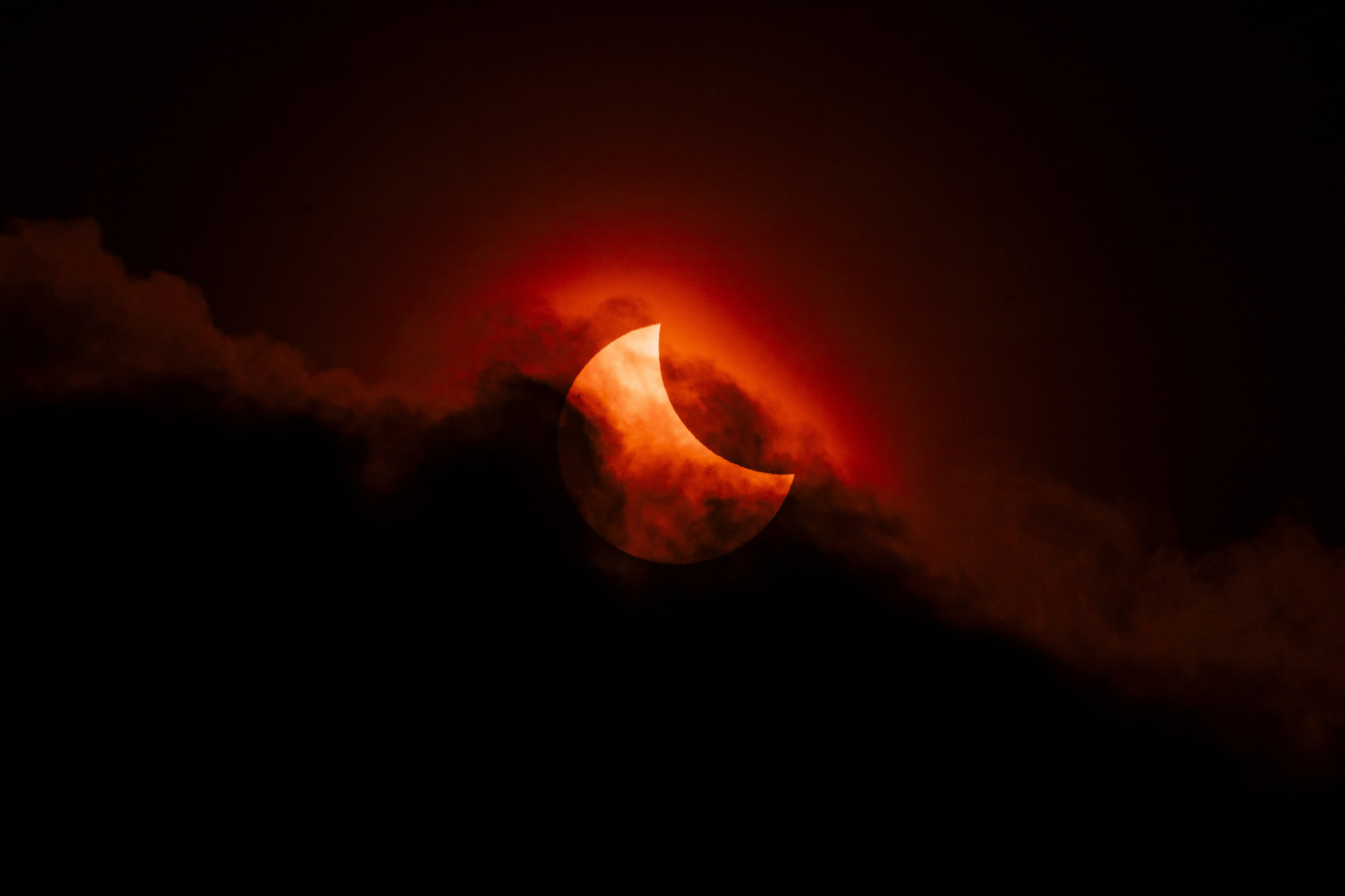 Our Sun. "Moody Partial Solar Eclipse" © James McBeath (UK). Here, the partial solar eclipse of 2025 was shot through fast-moving clouds on what was a beautiful spring morning. James McBeath spent several hours in a local park tracking the eclipse with his camera, showing many passers-by what he was doing and giving them a good view of the eclipse. McBeath ended up with hundreds of shots, but this one, with the clouds framing the Sun perfectly, immediately caught his eye. Taken with a Sony ILCE-7 camera, Canon EF 300 mm USM lens with 2x teleconverter, Sky-Watcher Star Adventurer Mini mount, Pig Iron 720-nm R-72 Infrared filter, 600 mm f/18, ISO 100, 1/3,200-second exposure. Location: Leeds, West Yorkshire, England, 29 March 2025