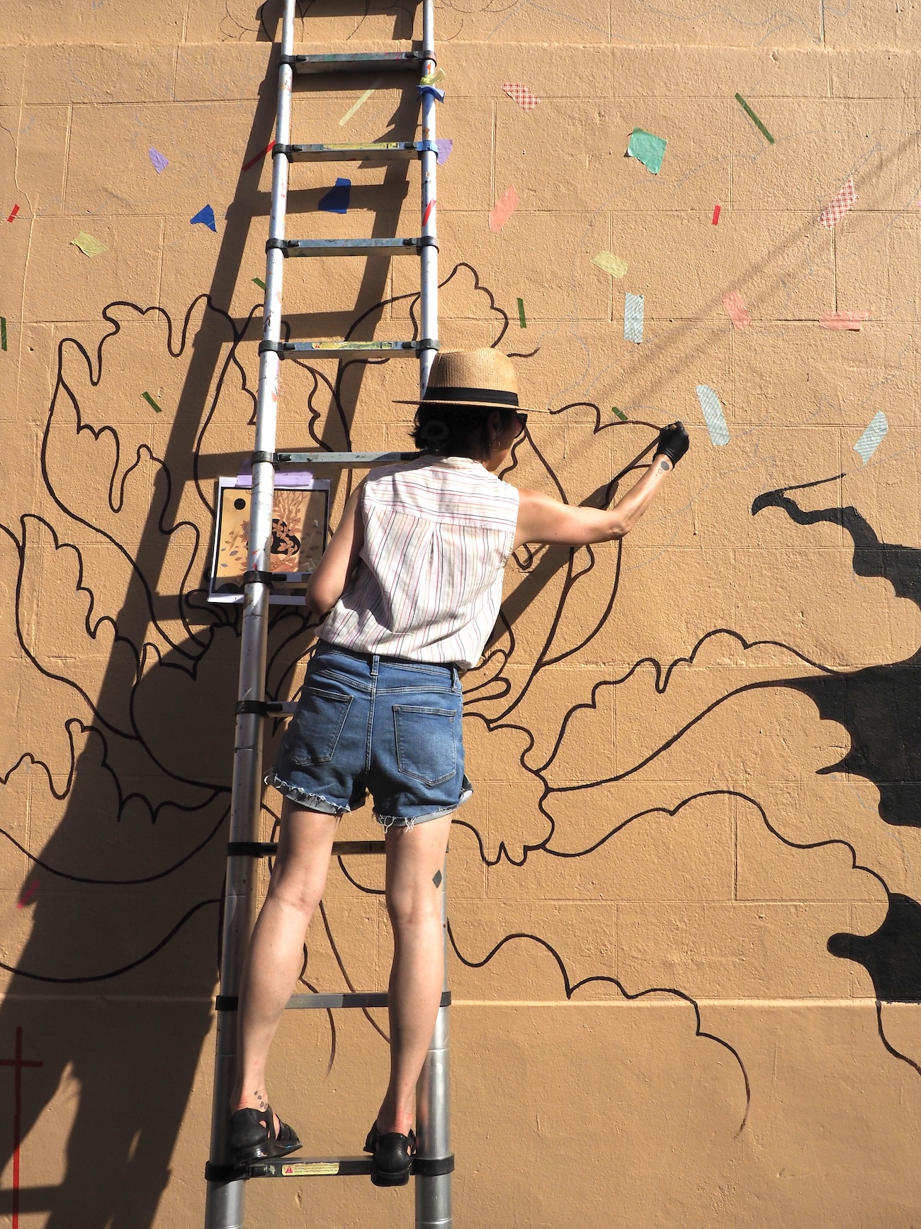 Audrey Kawasaki Working on Her Mural