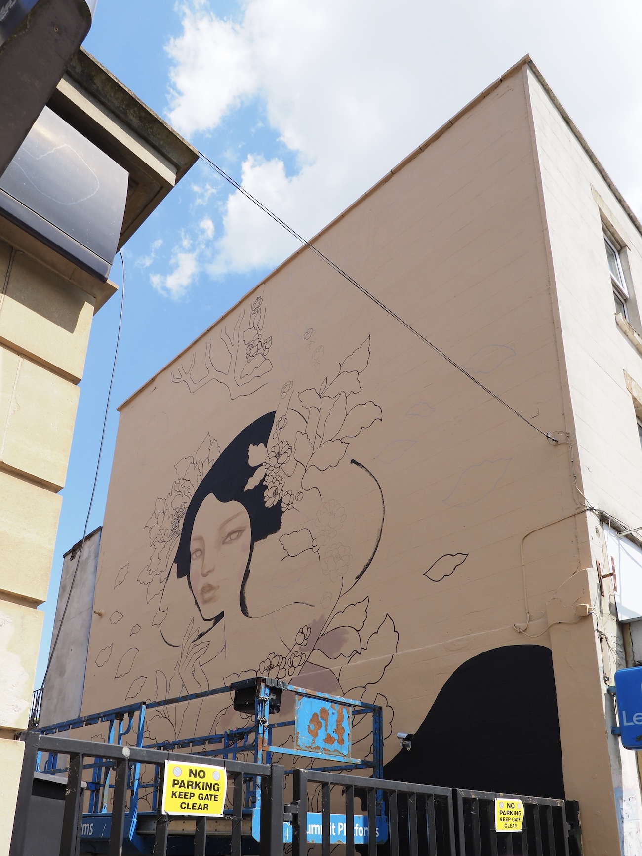 Audrey Kawasaki Working on Her Mural