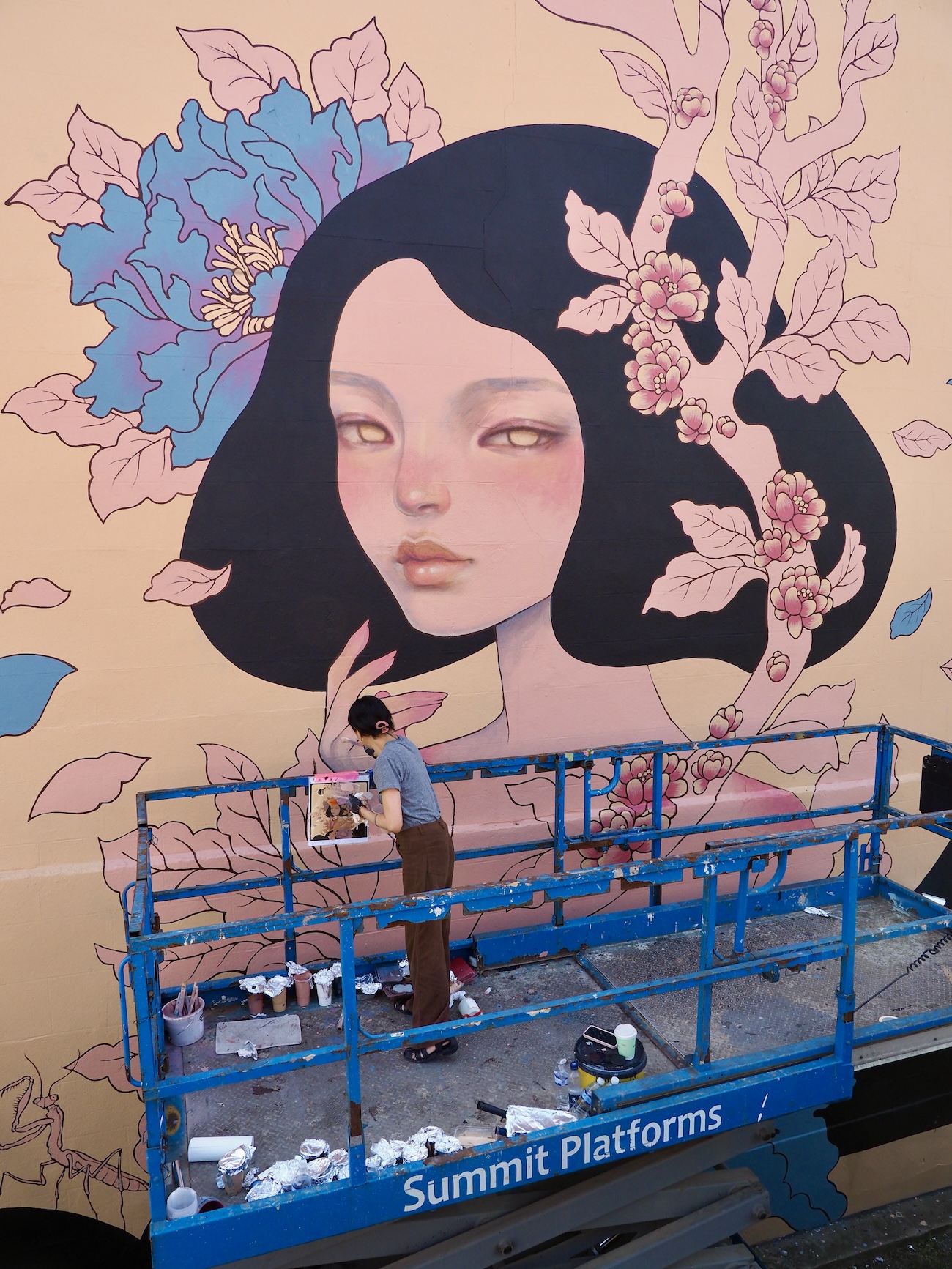 Audrey Kawasaki Working on Her Mural