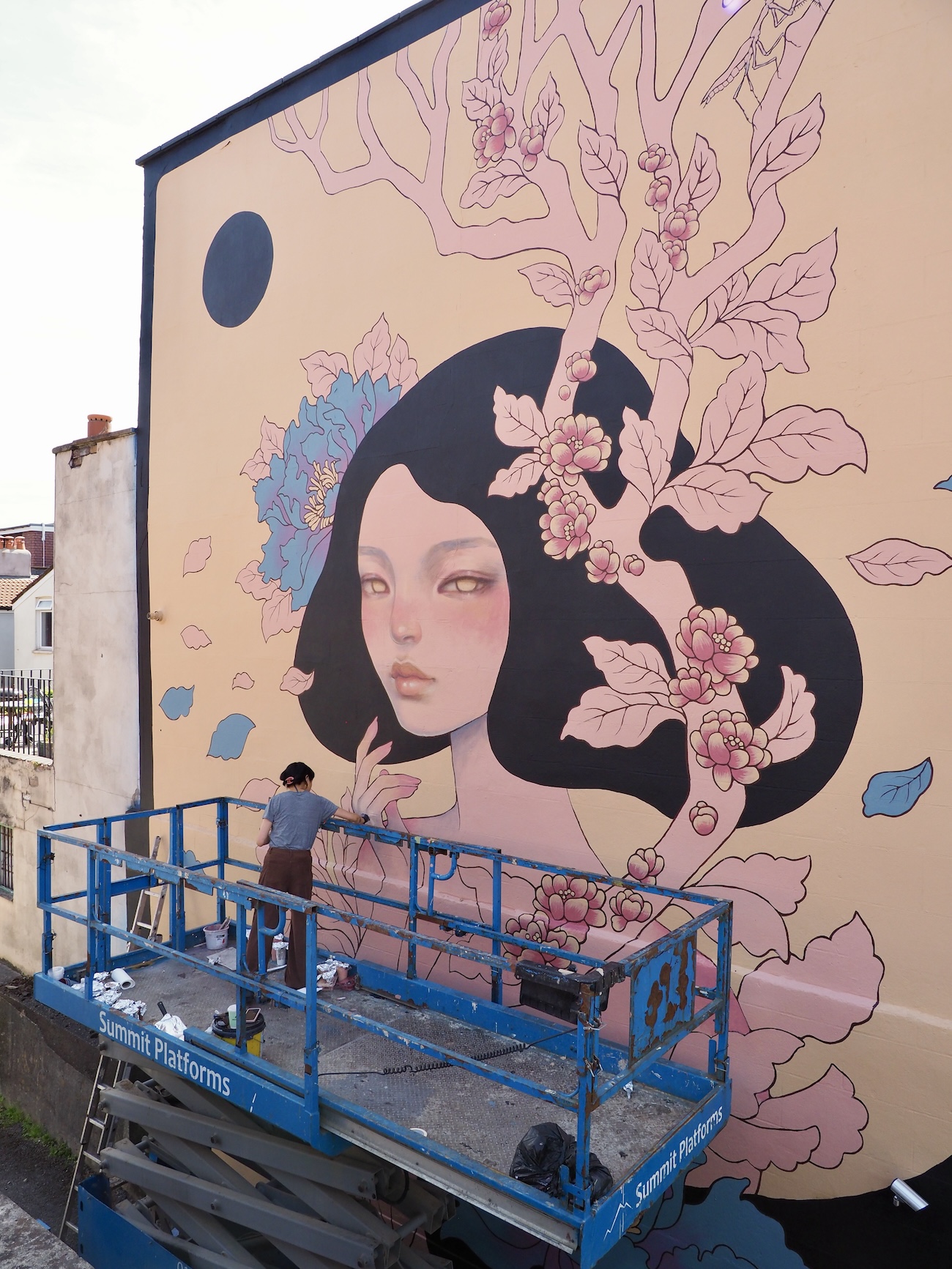 Audrey Kawasaki Working on Her Mural