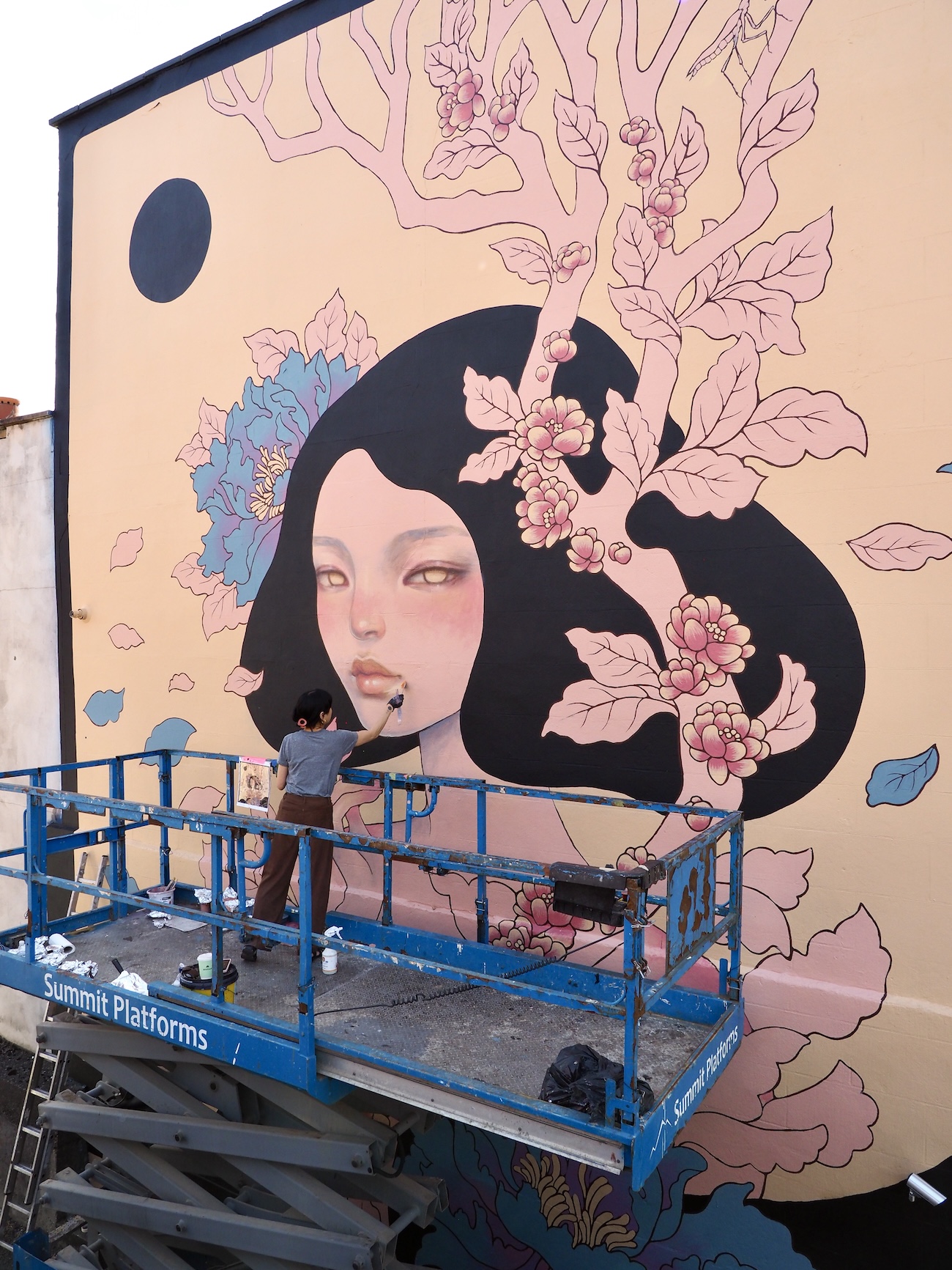 Audrey Kawasaki Working on Her Mural