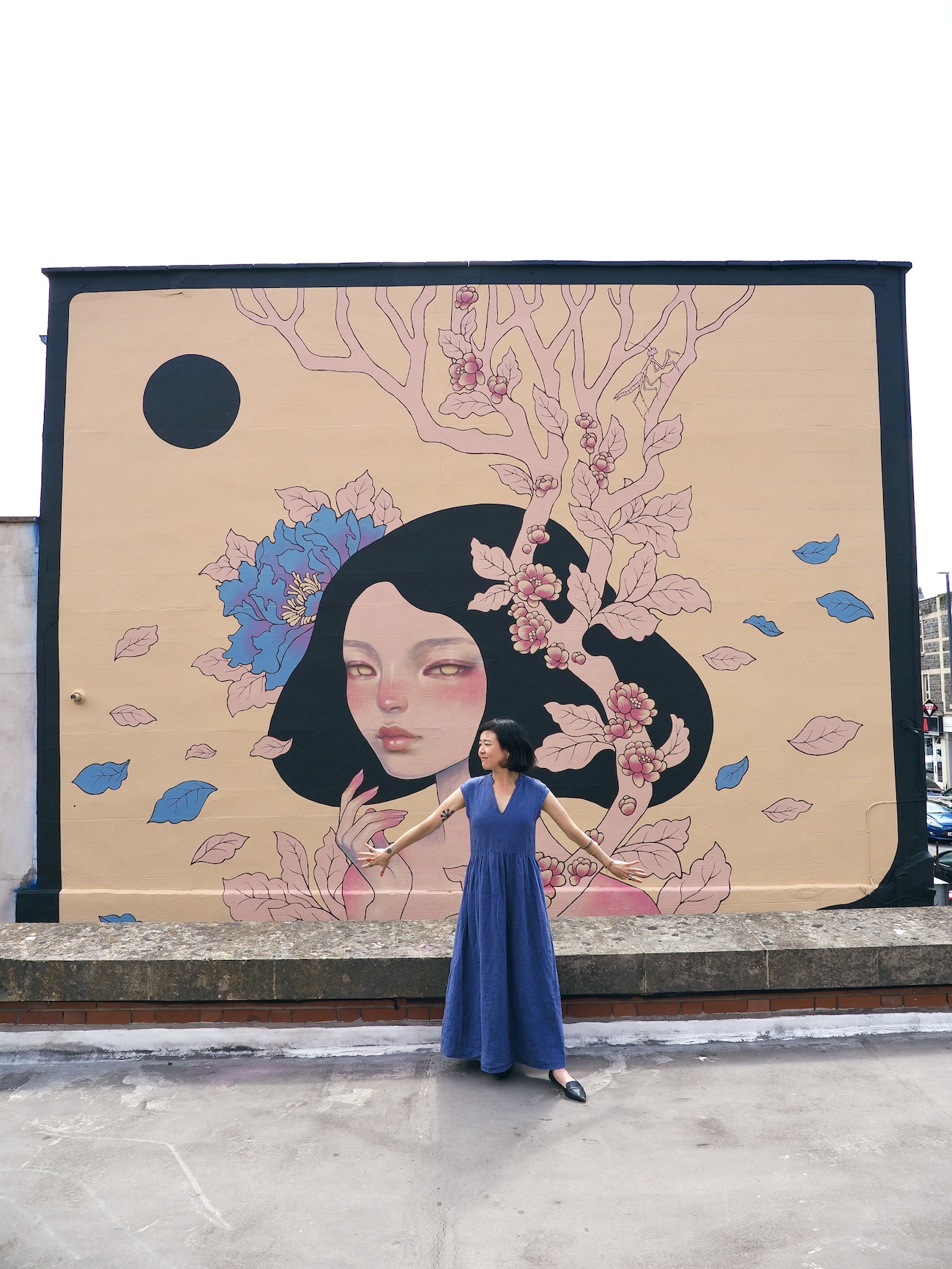 Audrey Kawasaki Posing in Front of Her Mural
