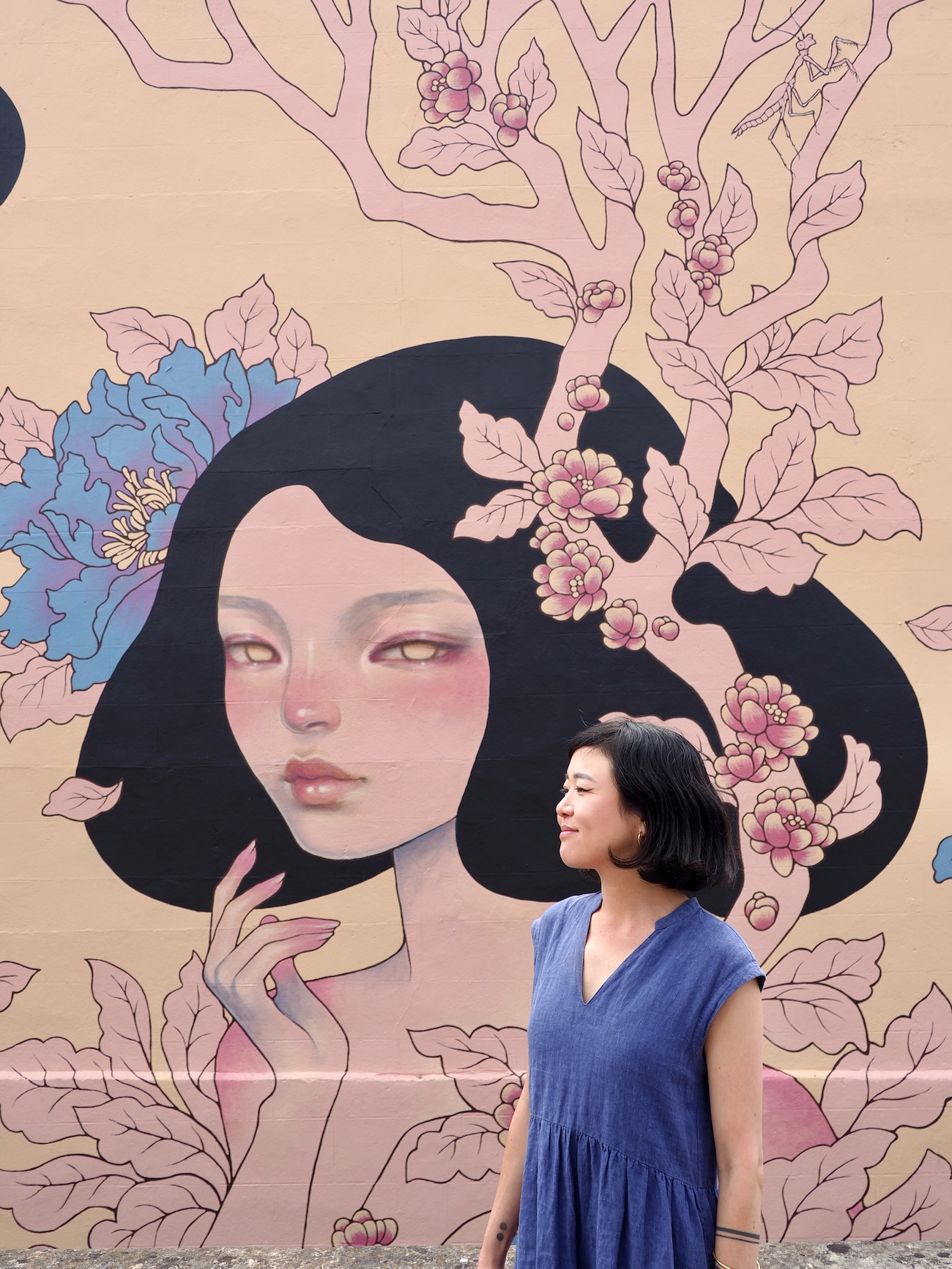 Audrey Kawasaki Posing in Front of Her Mural